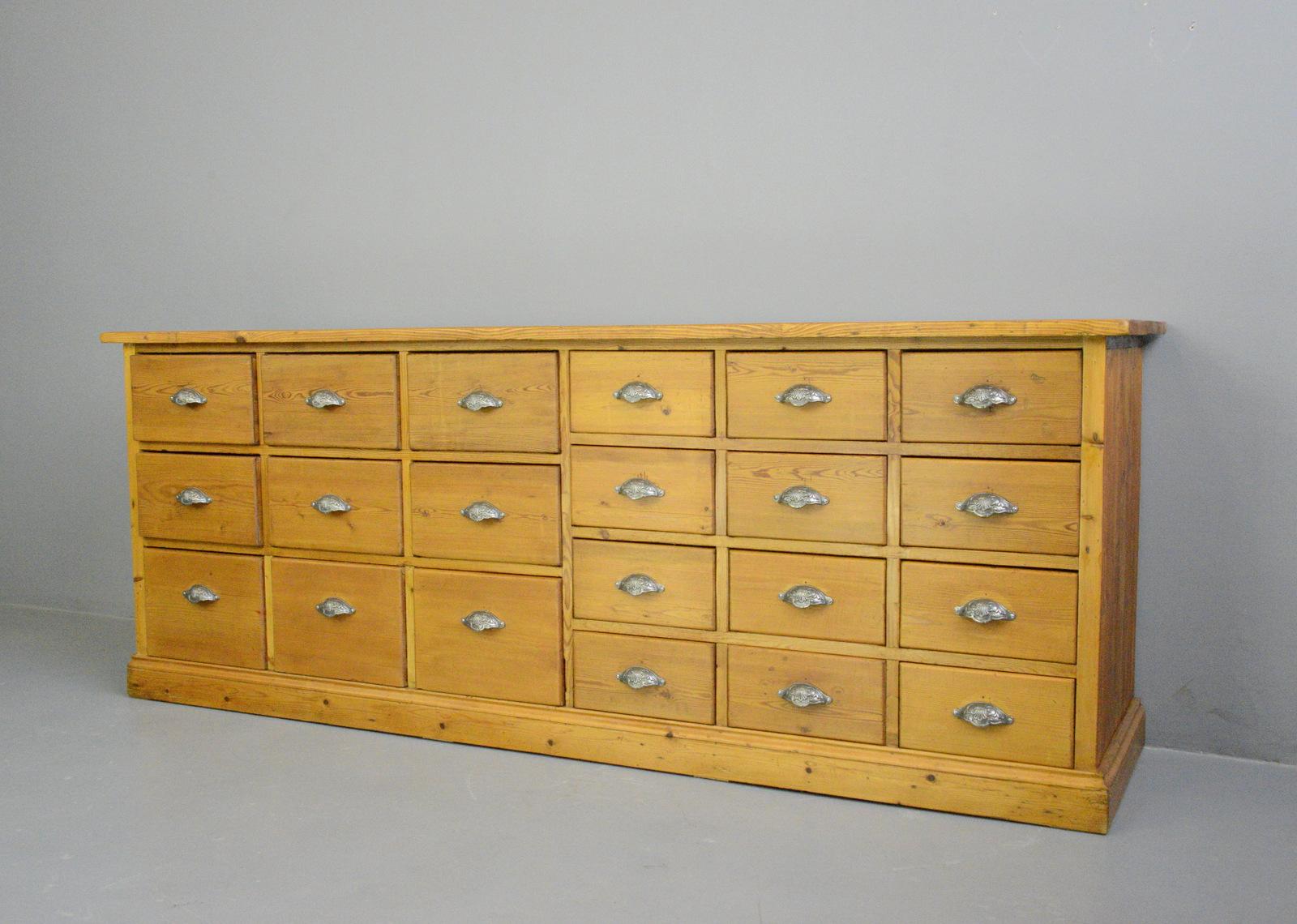 Pine bank of drawers Circa 1930s

- Solid pine drawers, frame and top
- Cast iron handles
- Dutch ~ 1930s
- Measures: 225cm long x 56cm deep x 86cm tall
- Smallest drawers measure 27cm wide x 43cm deep x 14cm tall
- Middle drawers measure