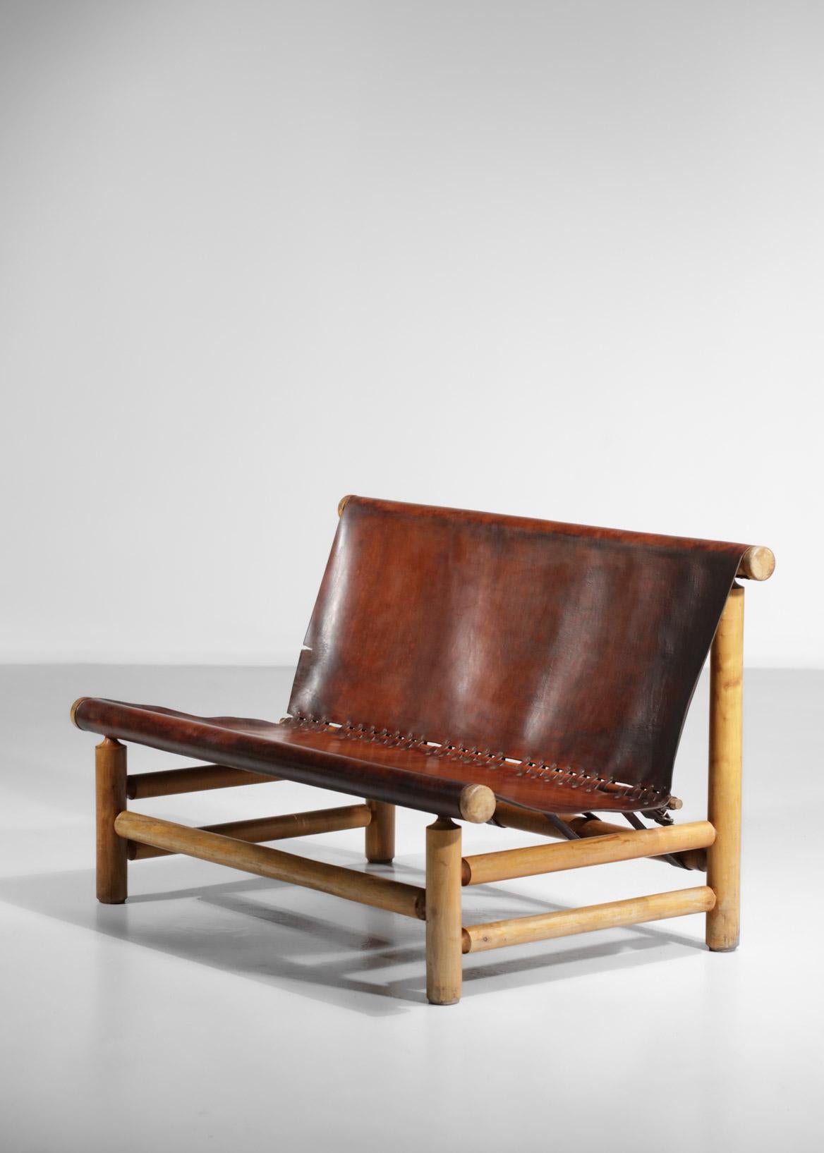 Very original bench from the 50's / 60's reminding the work of Charlotte Periand or Ilmarii Tapiovaraa. Structure in solid pine, seat and back in strapped cognac leather. Very nice patina of time on the leather which has been cleaned and rehydrated,