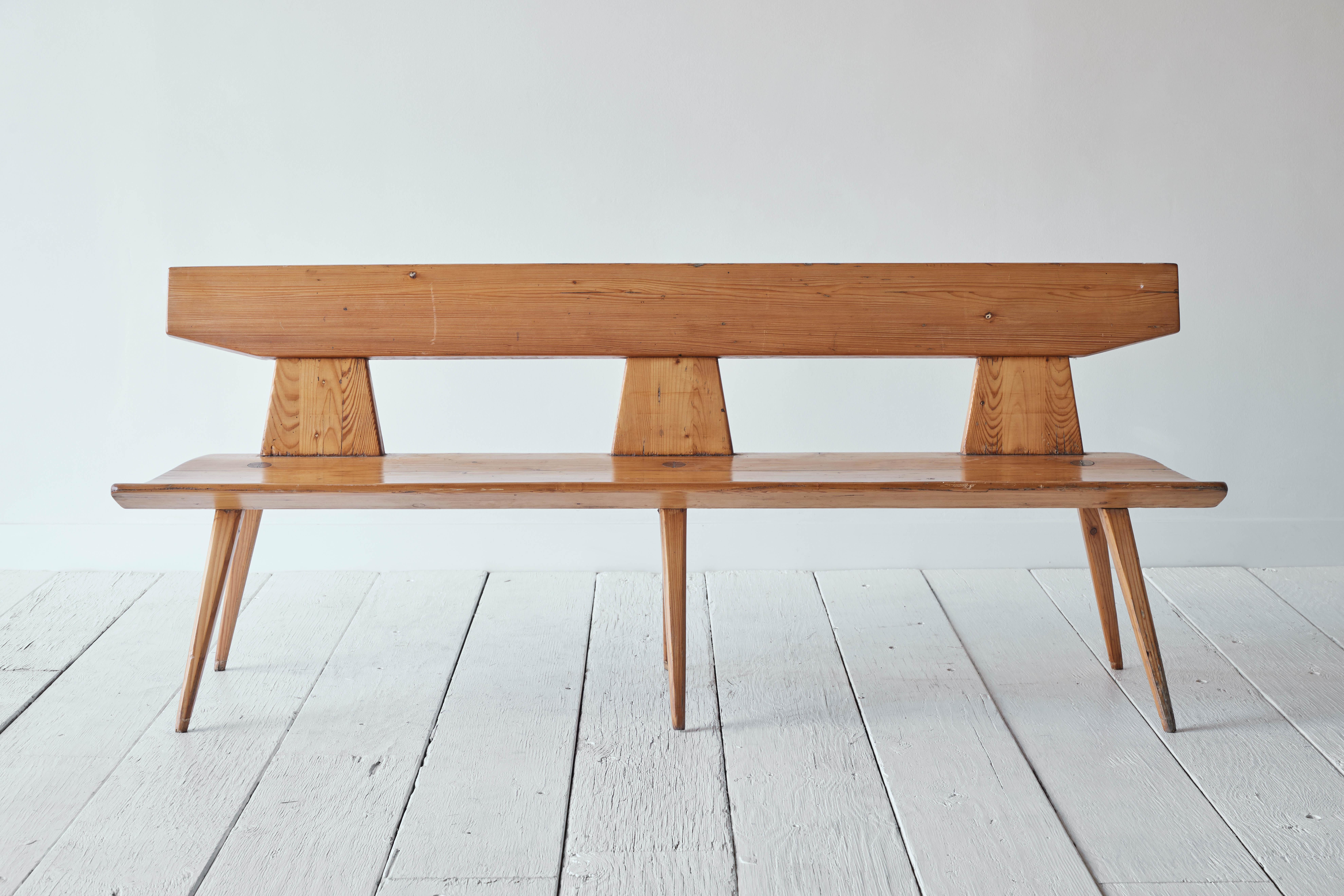 A handsome handcrafted pine wooden bench by Jacob Kielland Brandt for I. Christiansen in Denmark. This bench was made in the 1960's and is considered a recognizable Scandinavian Modern period piece based on its specific shape, elegant curves and