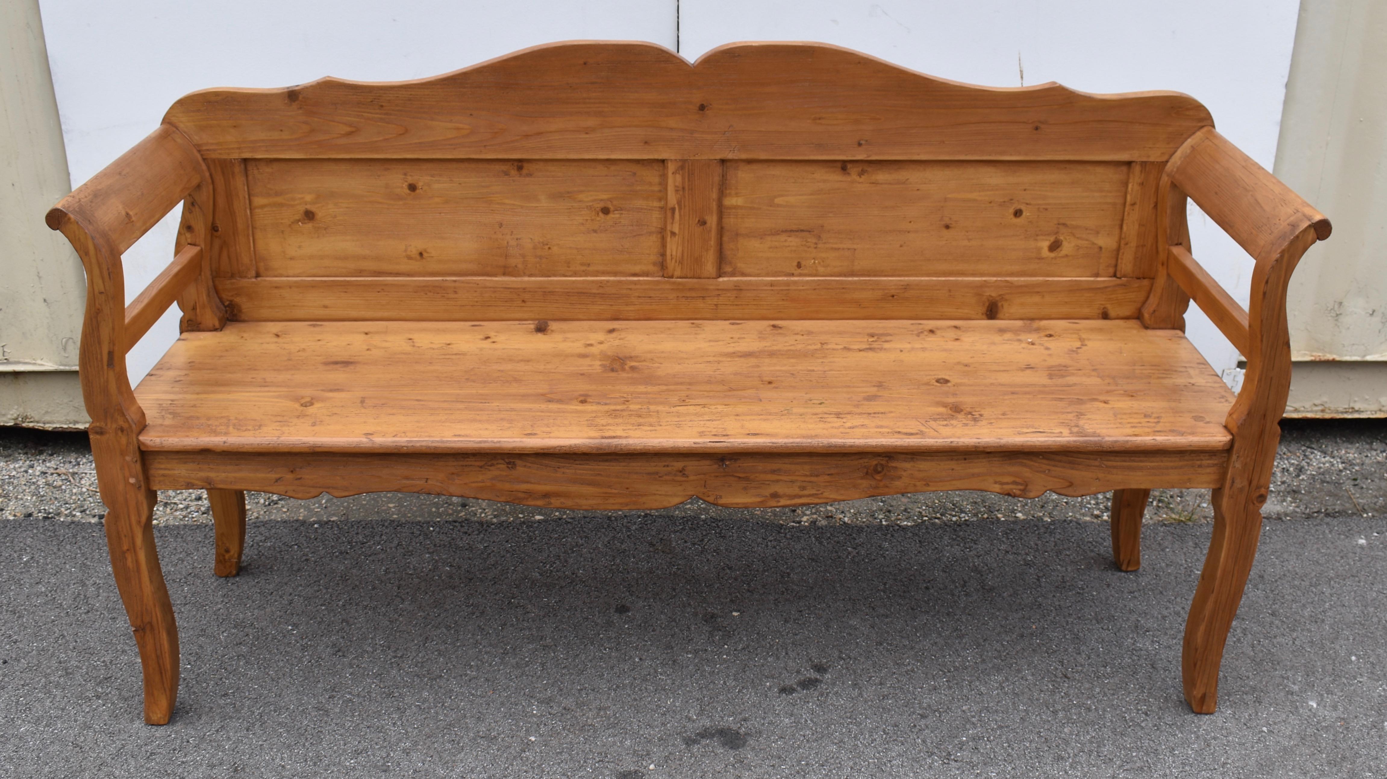 This is another fine example of a classic Central European settle.  The boldly scalloped back rail sits above two rectangular flat panels and the scallop pattern is repeated in the front rail beneath the seat.  The legs have a pronounced cabriole