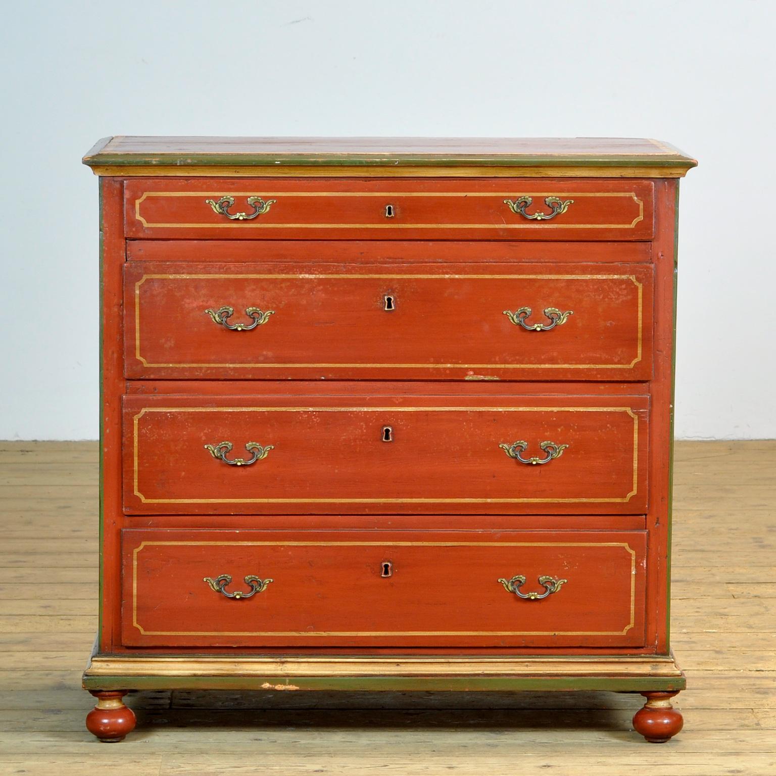 Chest of drawers made of pine, made in Germany circa 1920. The cabinet is painted in a beautiful red with green and yellow accents.
The cabinet has 4 drawers of which the top drawer is less high. The top drawer is divided into several compartments.