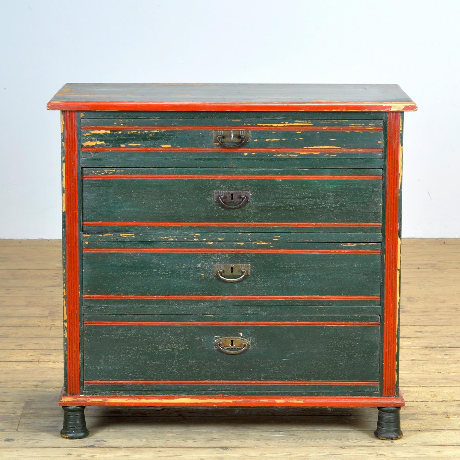 Chest of drawers made of pine, made in Austria circa 1920. The cabinet is painted in a beautiful green with accents of red.
The cabinet has 4 drawers with different heights. The drawers are made with dovetail joints. All fittings and knobs are