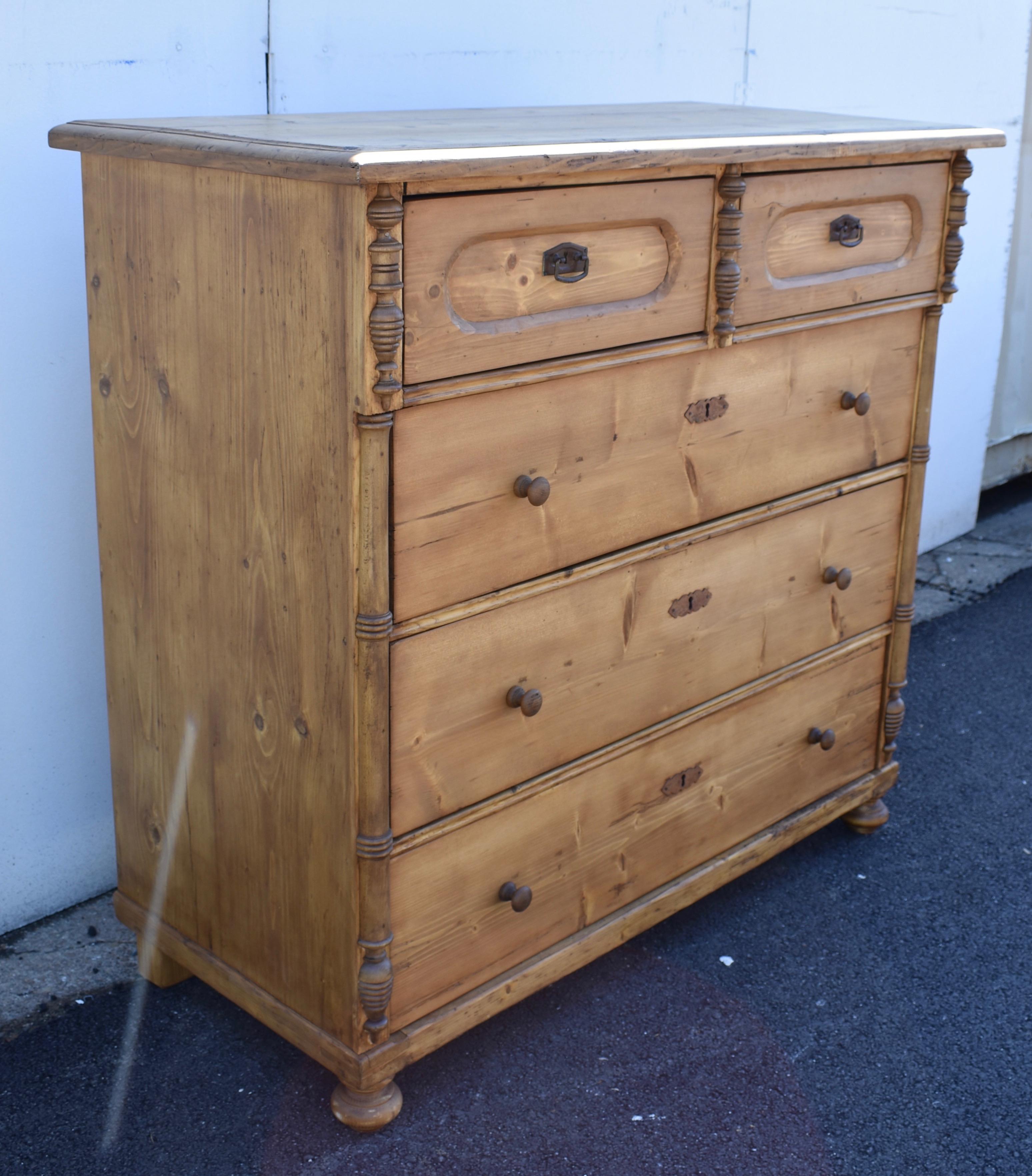 This large chest of two short drawers over three long offers lots of storage in a piece with good color and considerable presence.  The thick top has a step-down routed edge.  The two top drawers have oval faux panels and stand slightly proud of the