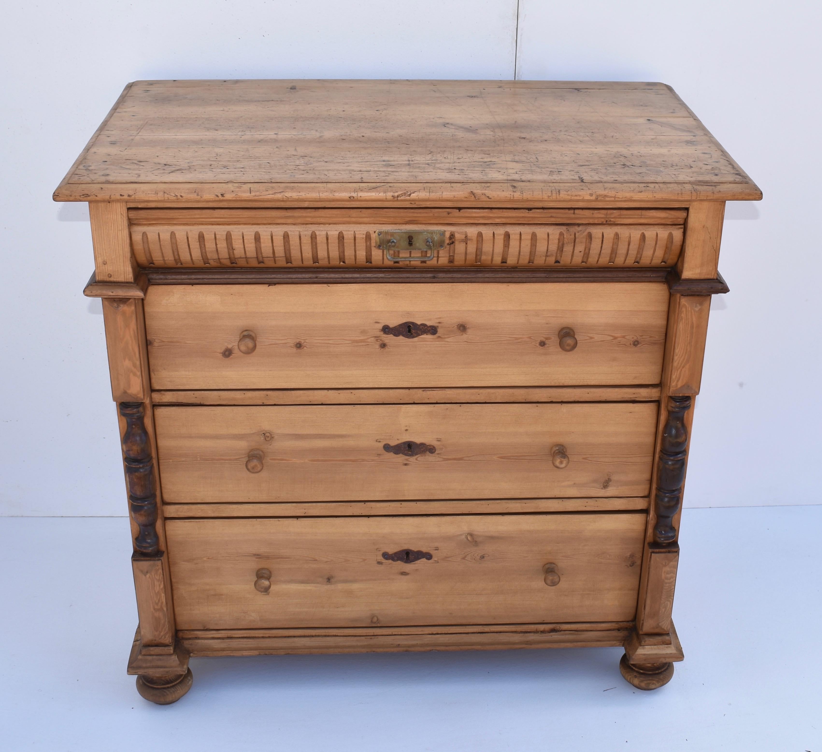 This is a lovely little Scandinavian chest of four drawers. The shallow top drawer has a convex front patterned with vertical flutes and with a single central brass bail pull. Three plain drawers follow, the bottom deeper than the others. The top