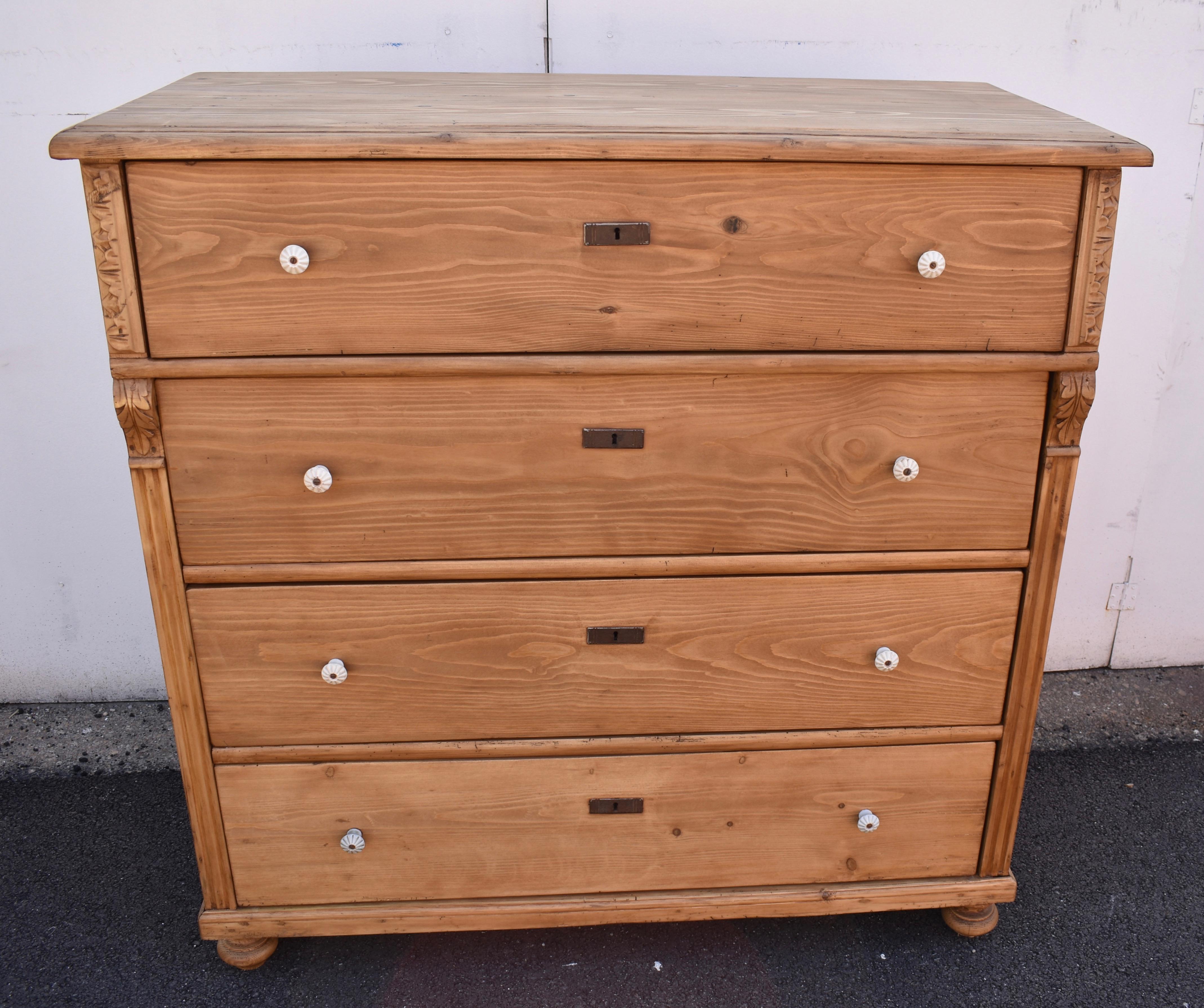 This massive chest of four deep hand-cut dovetailed drawers has the usual step-down edge to the top but at 23” deep it is more shallow than most chests as tall and wide as this one. The front corners have applied fluting and acanthus leaf corbels