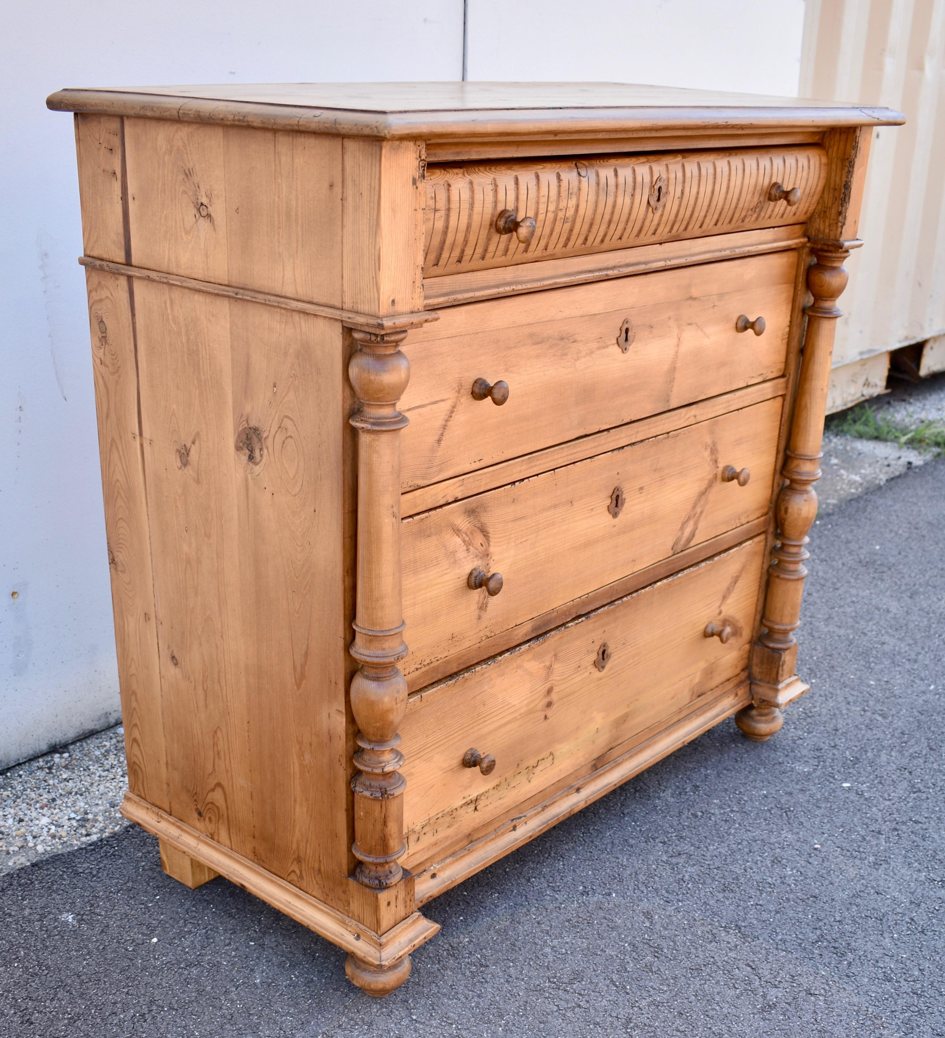 What an attractive chest of drawers and what beautiful hand-cut dovetailed and pegged construction.  The case has a step-down edge to the top, which is attached to the sides with hardwood pegs.  The front corners are adorned with full turned columns