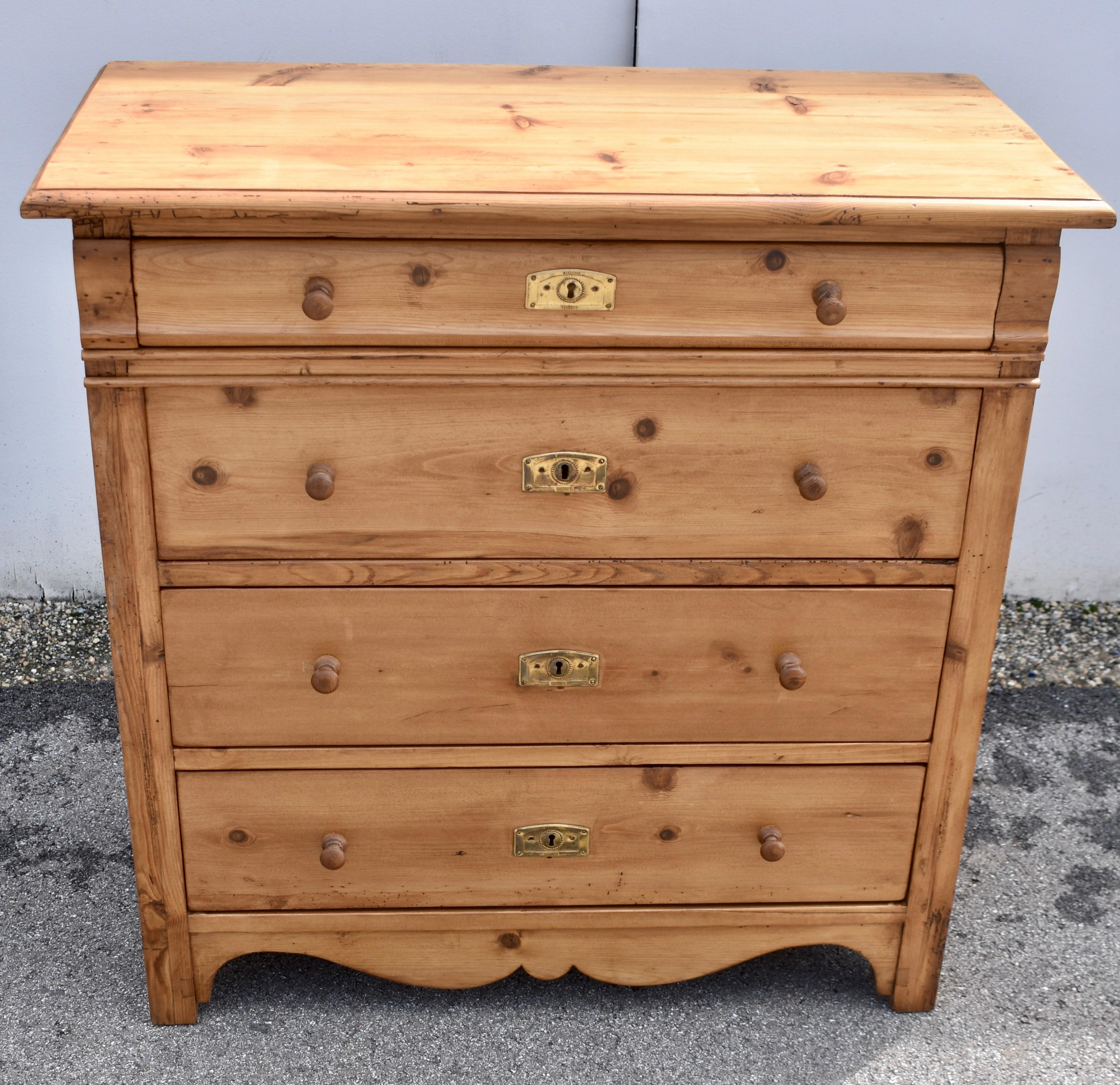  This beautifully compact chest of four drawers has a lovely golden color hand-polished to a rich honey glow.  The top has a shallow routed step-down edge and the front corners of the case are plain, except for an ogee corbel on each side of the top