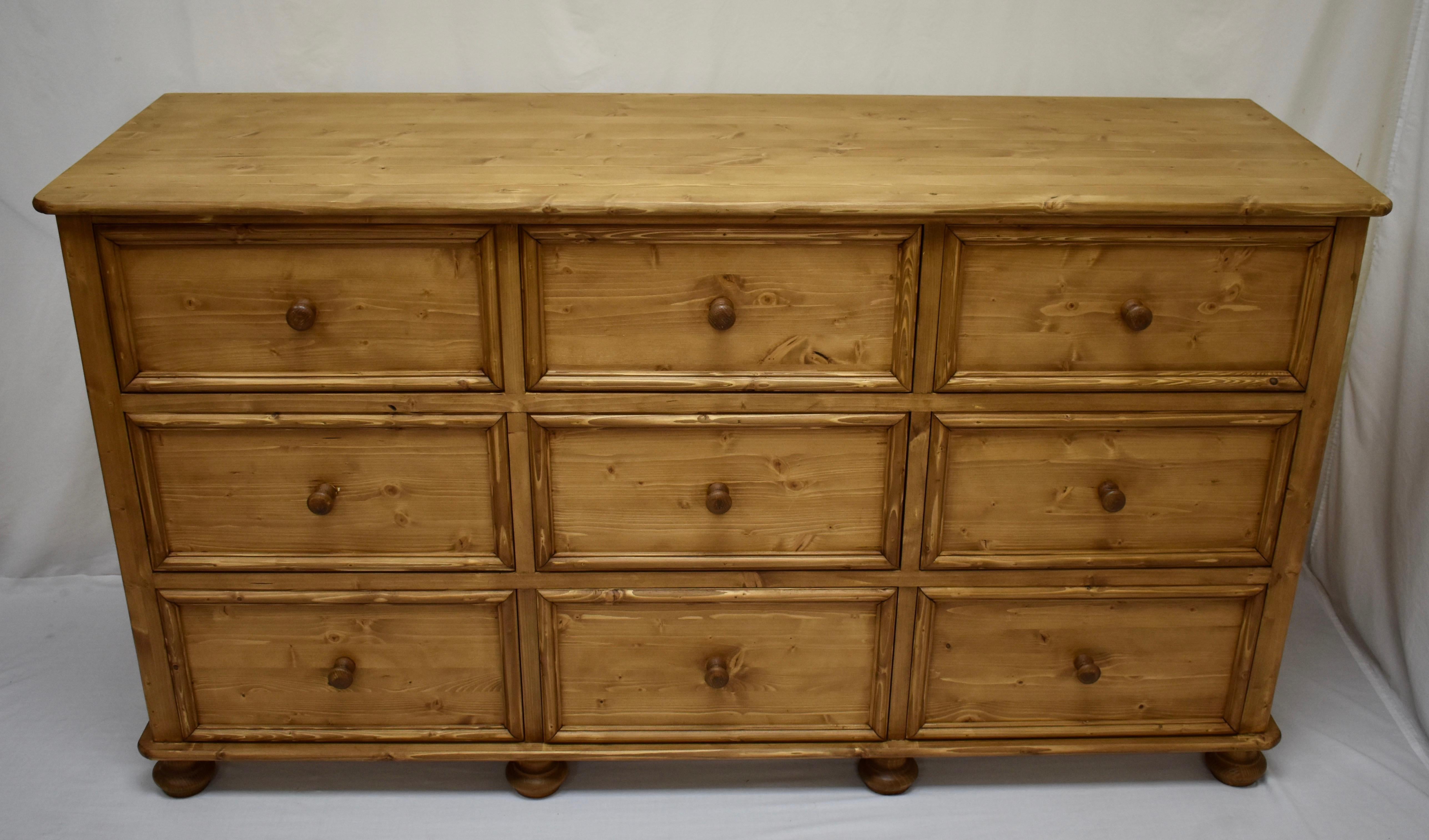 Long chests of drawers can be hard to find in antique pine so our workshop in Europe takes lightly-used reclaimed pine to build this piece using design features and methods of construction seen on our antique pieces. This long chest of nine slightly