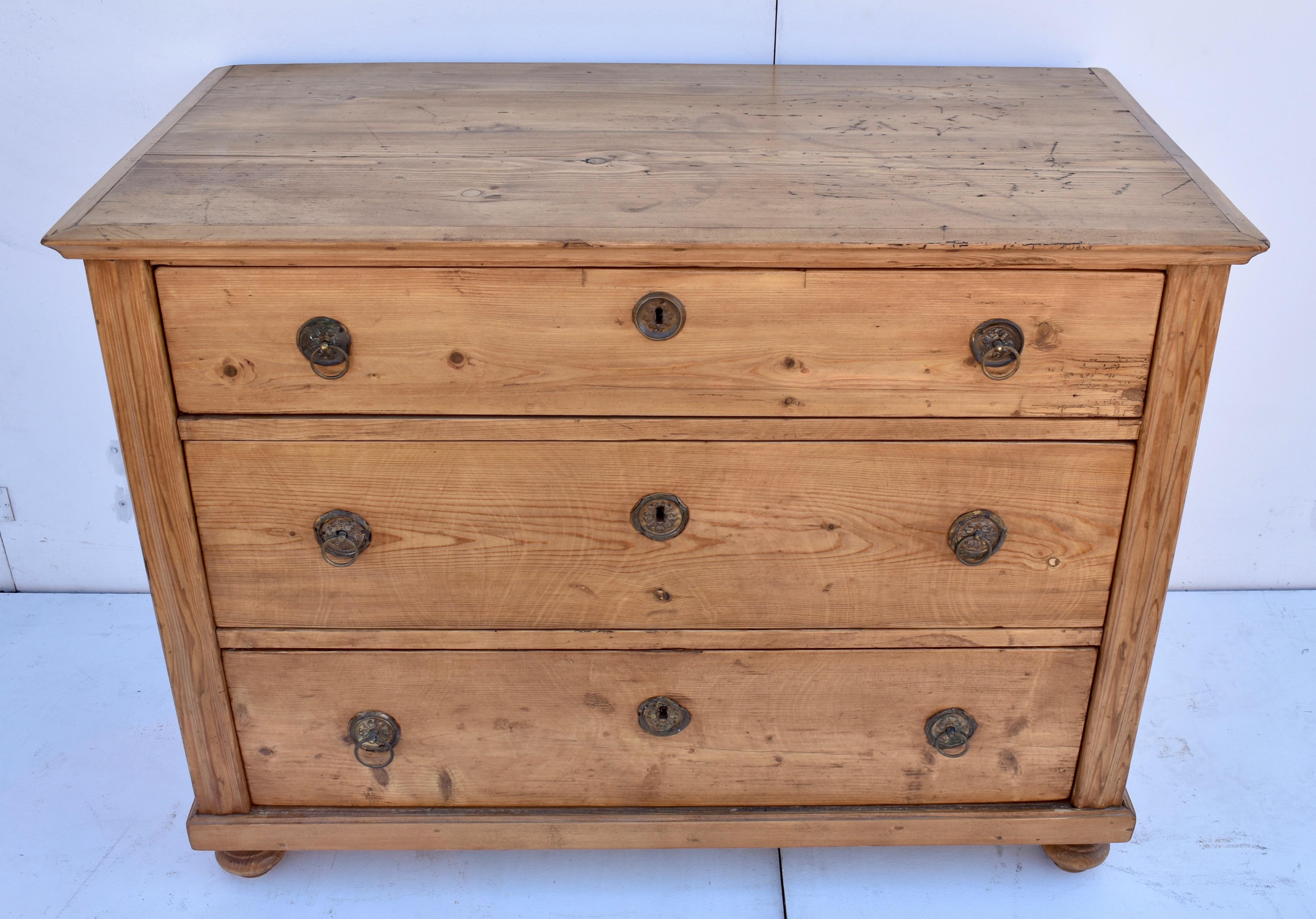 This heavy and sturdy chest has a beautiful top, bordered with ogee crown molding and the front corners have bold fluting. The three hand-cut dovetailed drawers are different depths but are not graduated top to bottom, as is usual. Each one has two