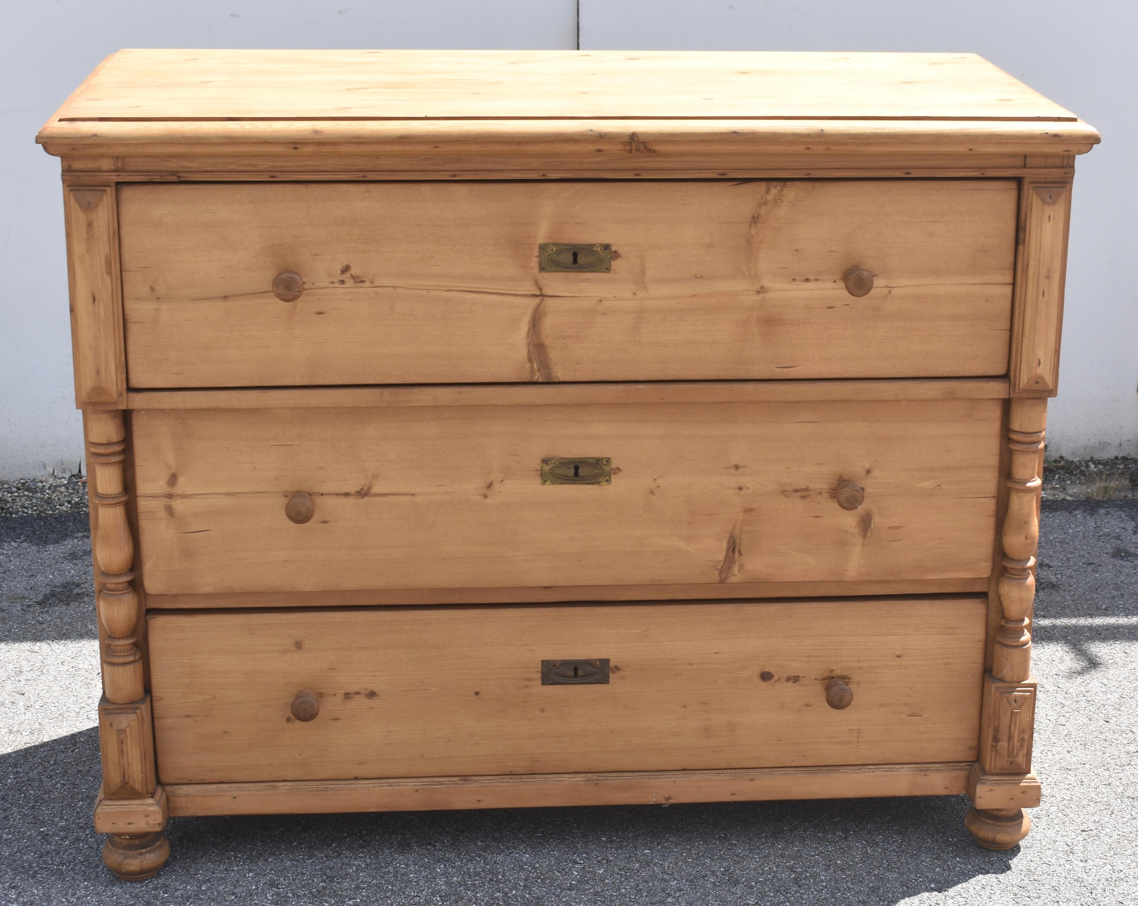  A hand-shaped applied ogee molding creates a step-down edge to the top of this large three drawer chest.  The hand-cut dovetailed drawers are of equal depth, the top one standing slightly proud of the lower two, which are flanked by full turned