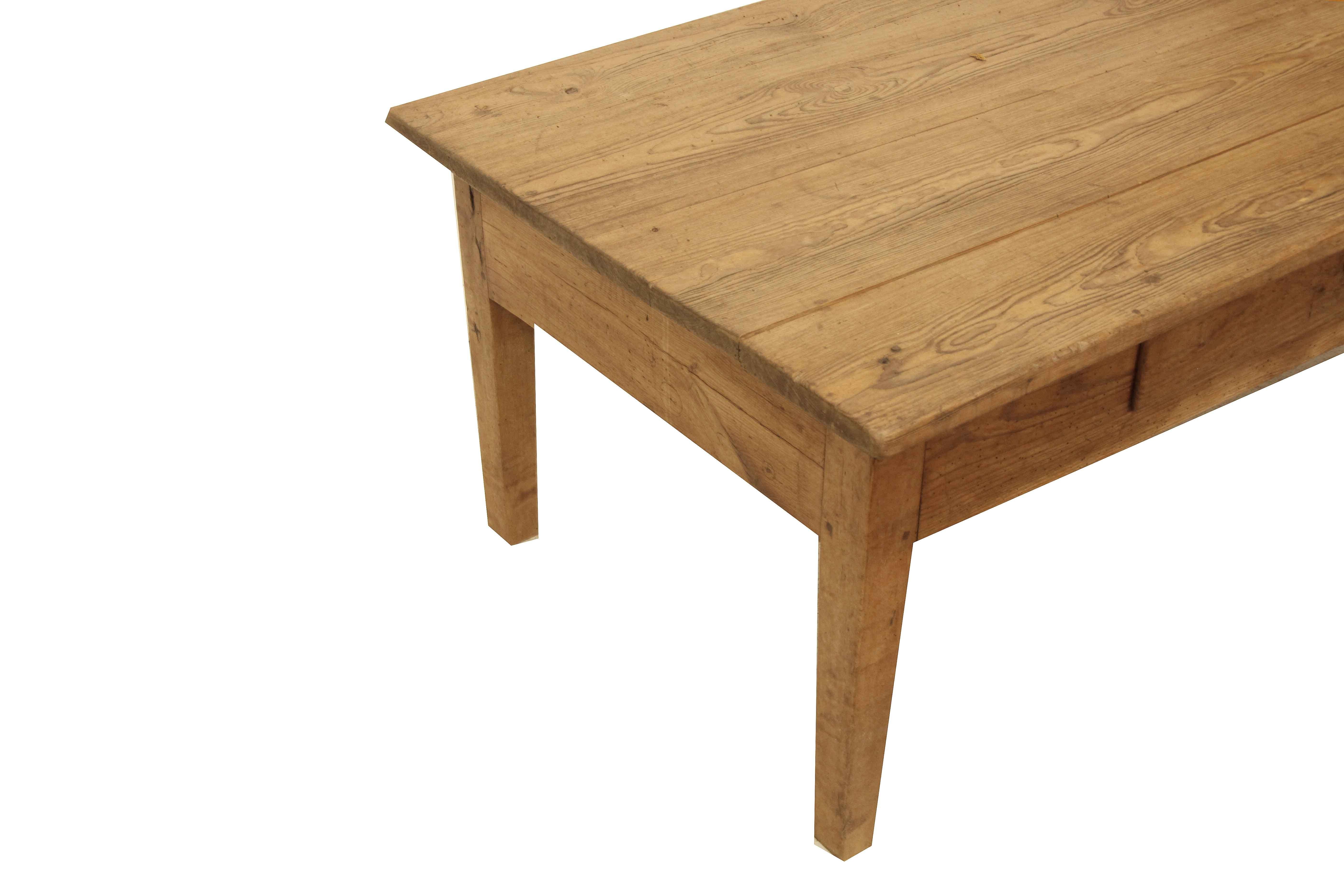 Pine coffee table, the top has a nice weathered patina, the single drawer has a steel ring pull ( there is a triangular repair in the upper right hand corner) , the tapered legs are made of beech and have double exposed pegs.