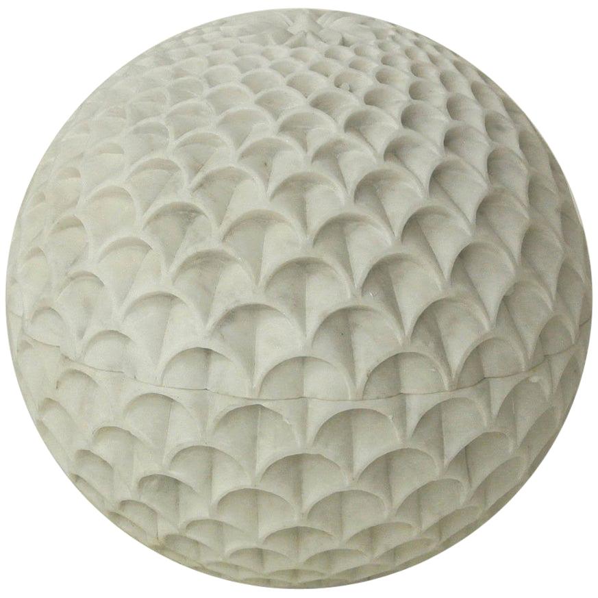 Inspired by the Pinecone, Paul Mathieu designed this beautiful floor/outdoor lighting fixture. Solid pieces of marble are first turned into hemispherical halves and hand-carved to create the intricate carving motif which plays with the translucent