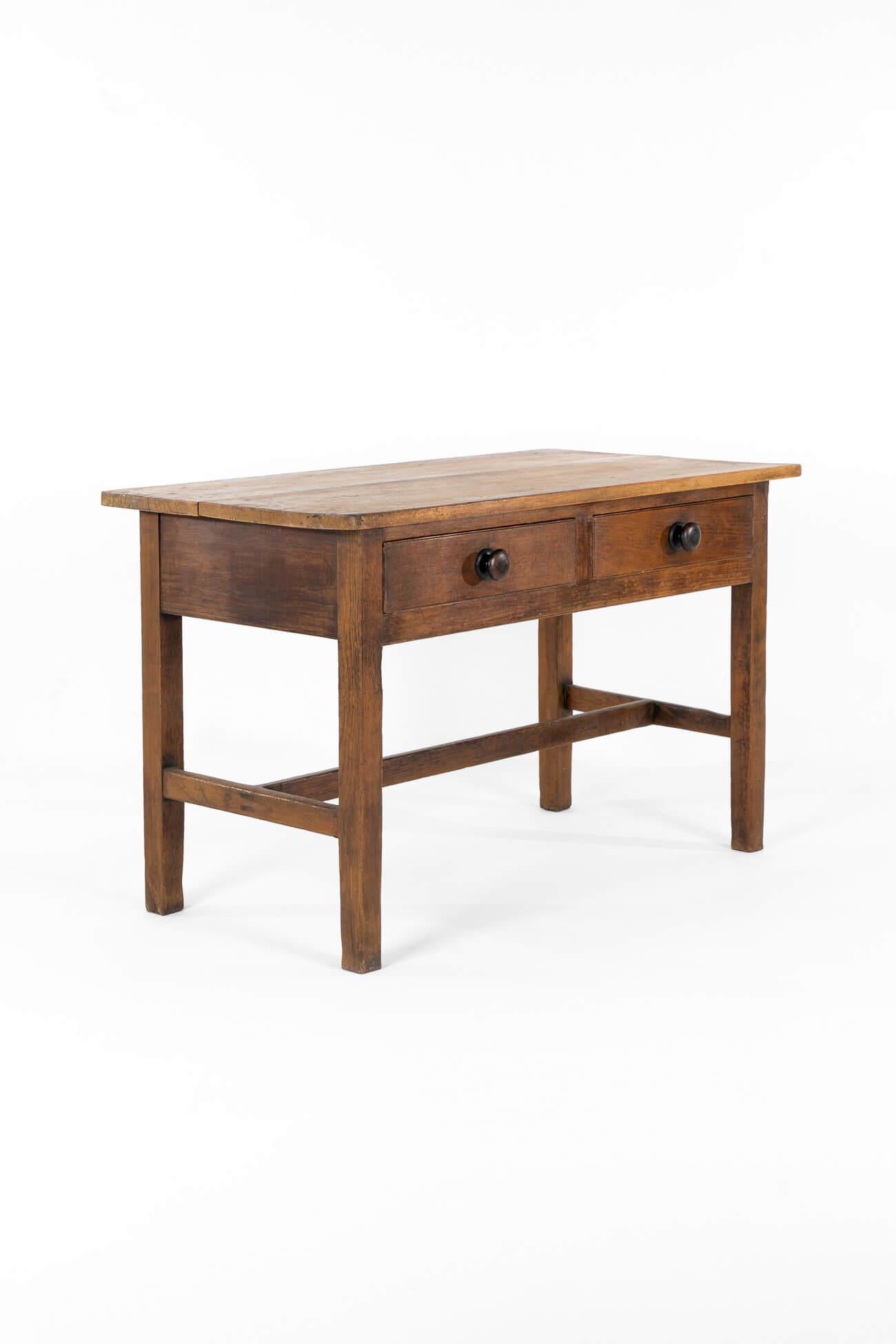 A generously proportioned Welsh dairy table in pine, with a wonderful two-plank top.

Two smooth-running central drawers with ebonised handles.

Raised on box legs and united by an H-stretcher.

Wales, circa 1880.

L: 122 CM  L: 48.1 INCHES

W: 66