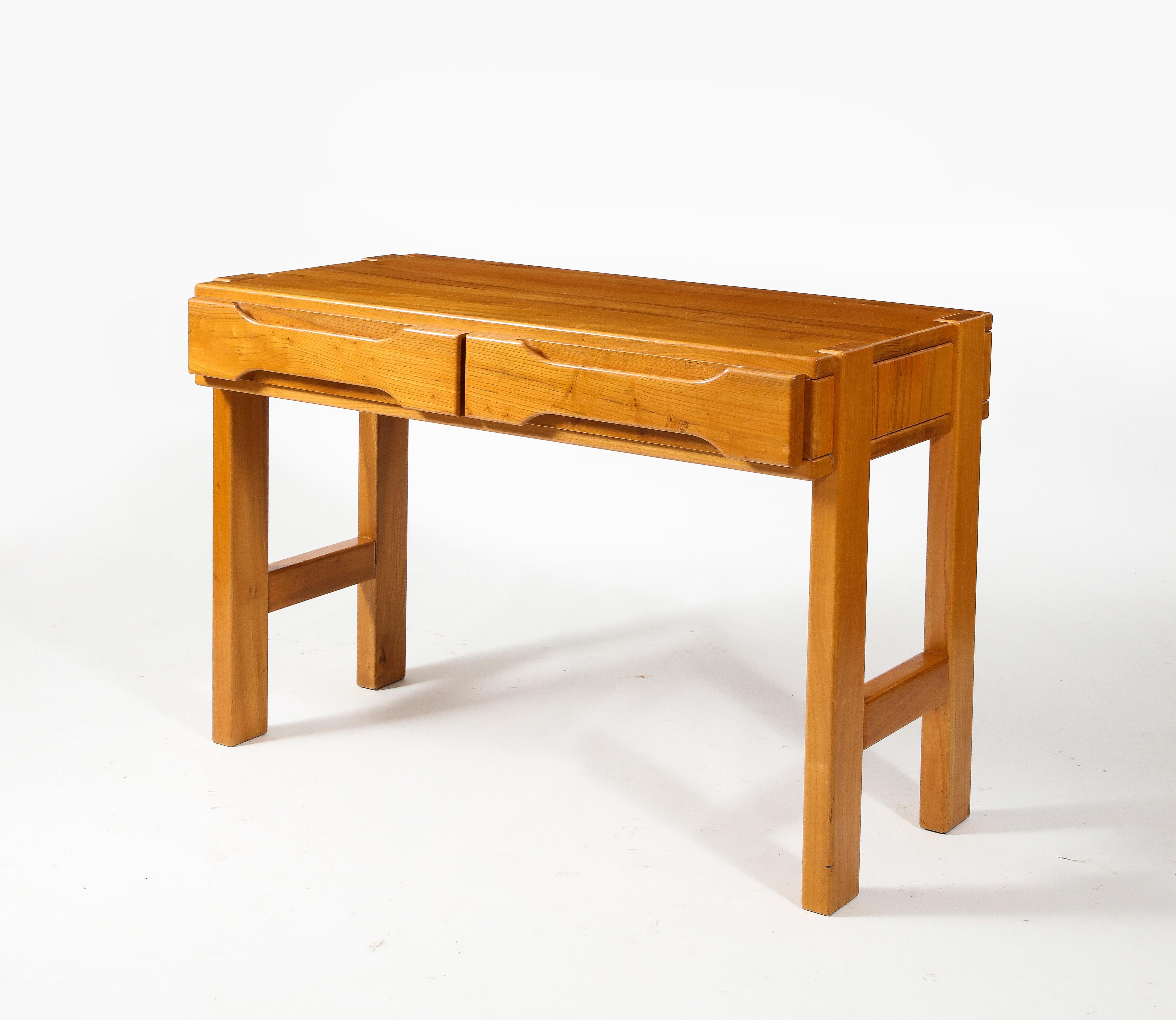 Brutalist desk in solid pine by Maison Regain. Elegant and solid construction with an intricate dowel system and handles directly cut in the drawer's faces. Original patina.