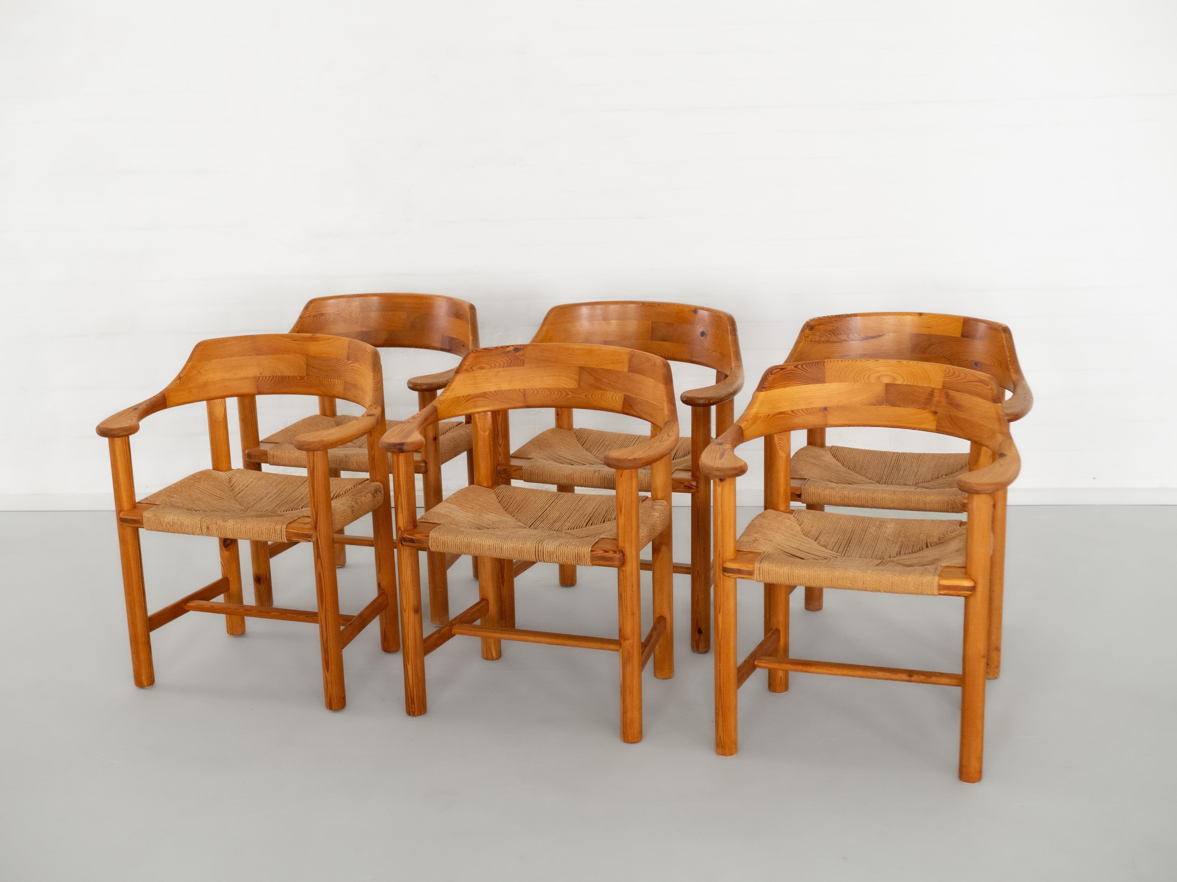This set of six sculptural dining chairs was designed by Rainer Daumiller and produced by Hirtshals Savvaerk in Denmark during the 1970s. Crafted from solid pine wood, the chairs reflect Daumiller’s appreciation for organic forms and natural