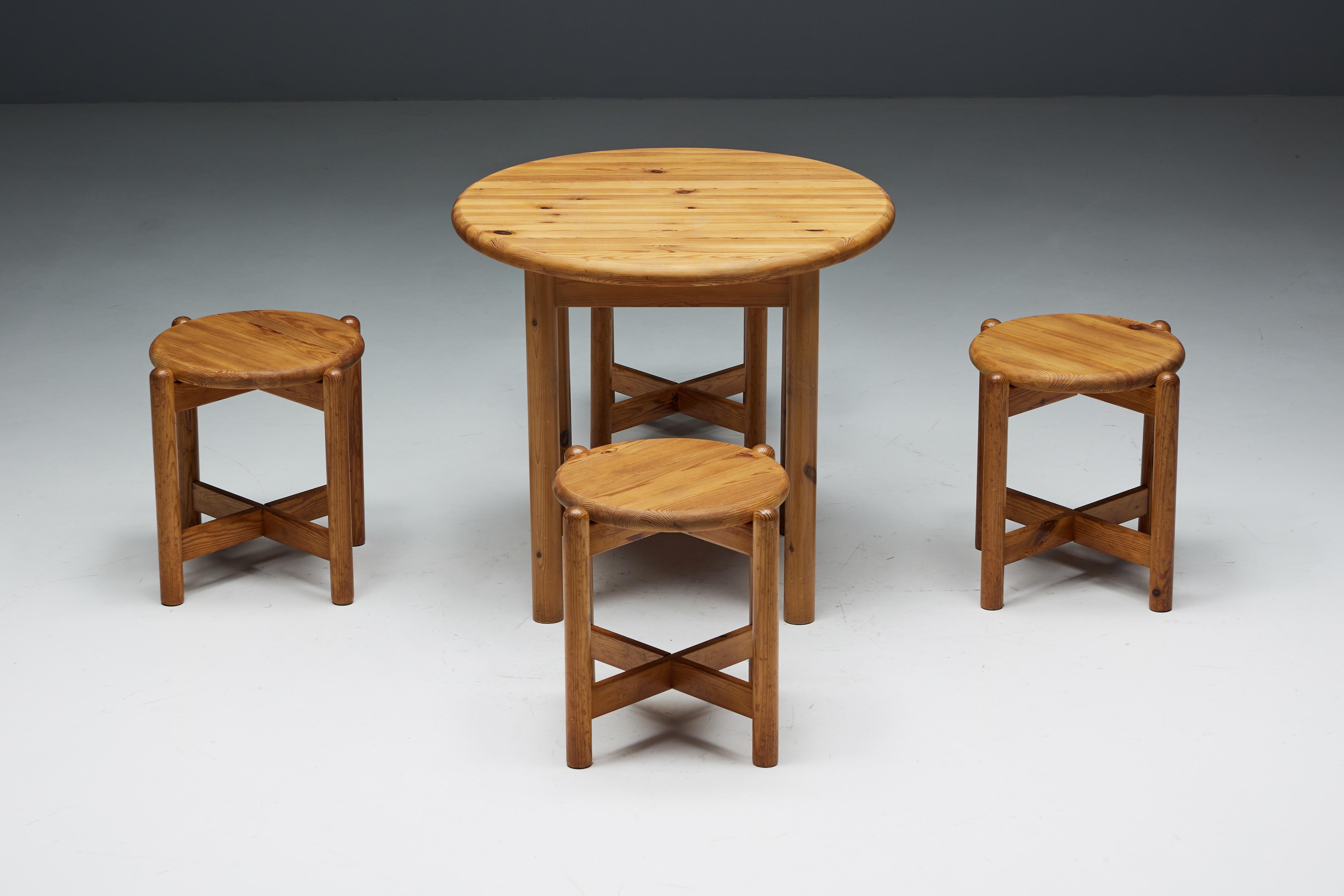1970s dining set by Rainer Daumiller, crafted entirely from solid pine. This timeless ensemble comprises a robust round dining table and four accompanying stools, each bearing the unmistakable hallmark of Daumiller's craftsmanship. The dining