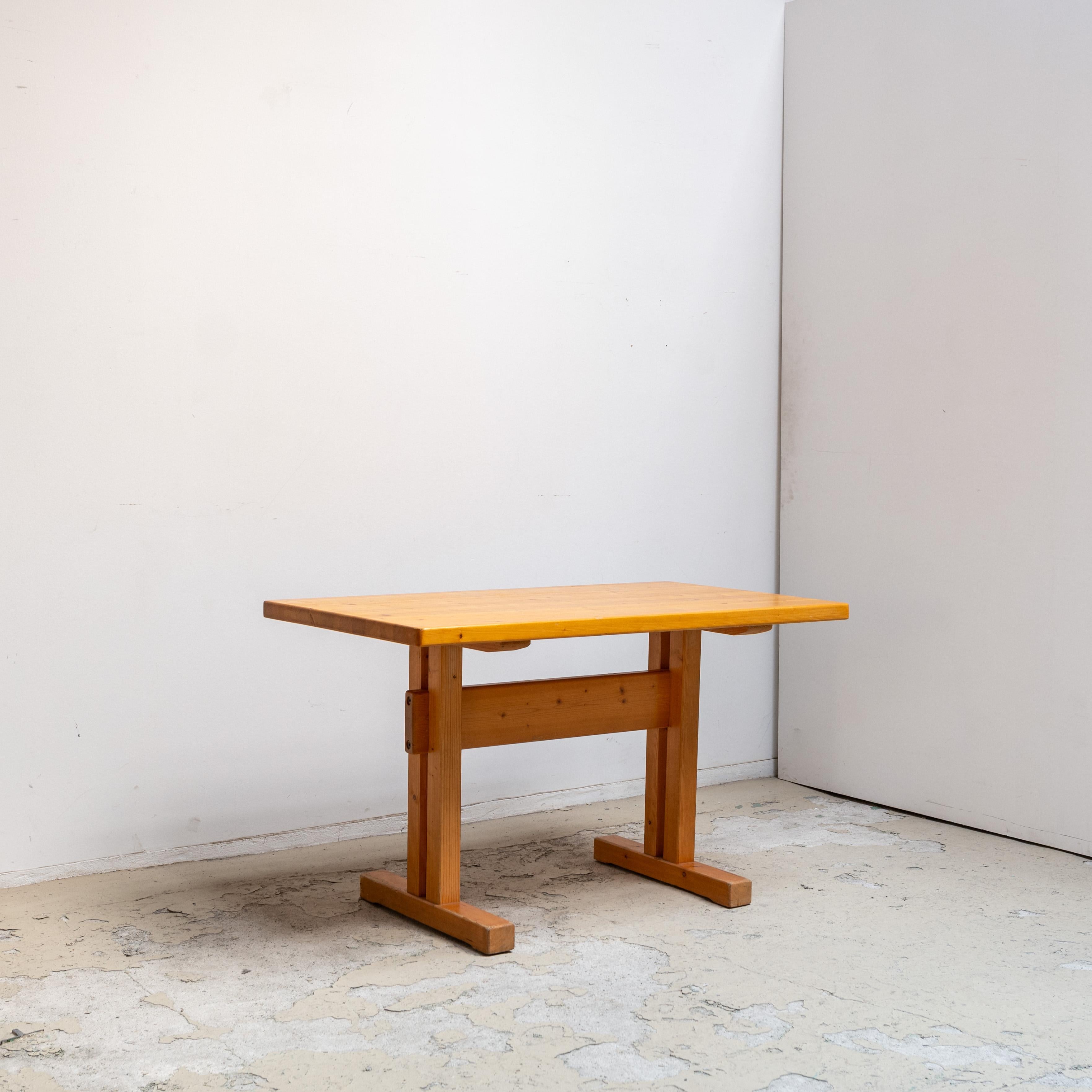The pine table, that was designed by Charlotte Perriand for Les Arcs.
 
Les Arcs is the first ski resort built for the general public in the Savoie region of France, created in 1967. The project was led by Charlotte Perriand, with renowned
