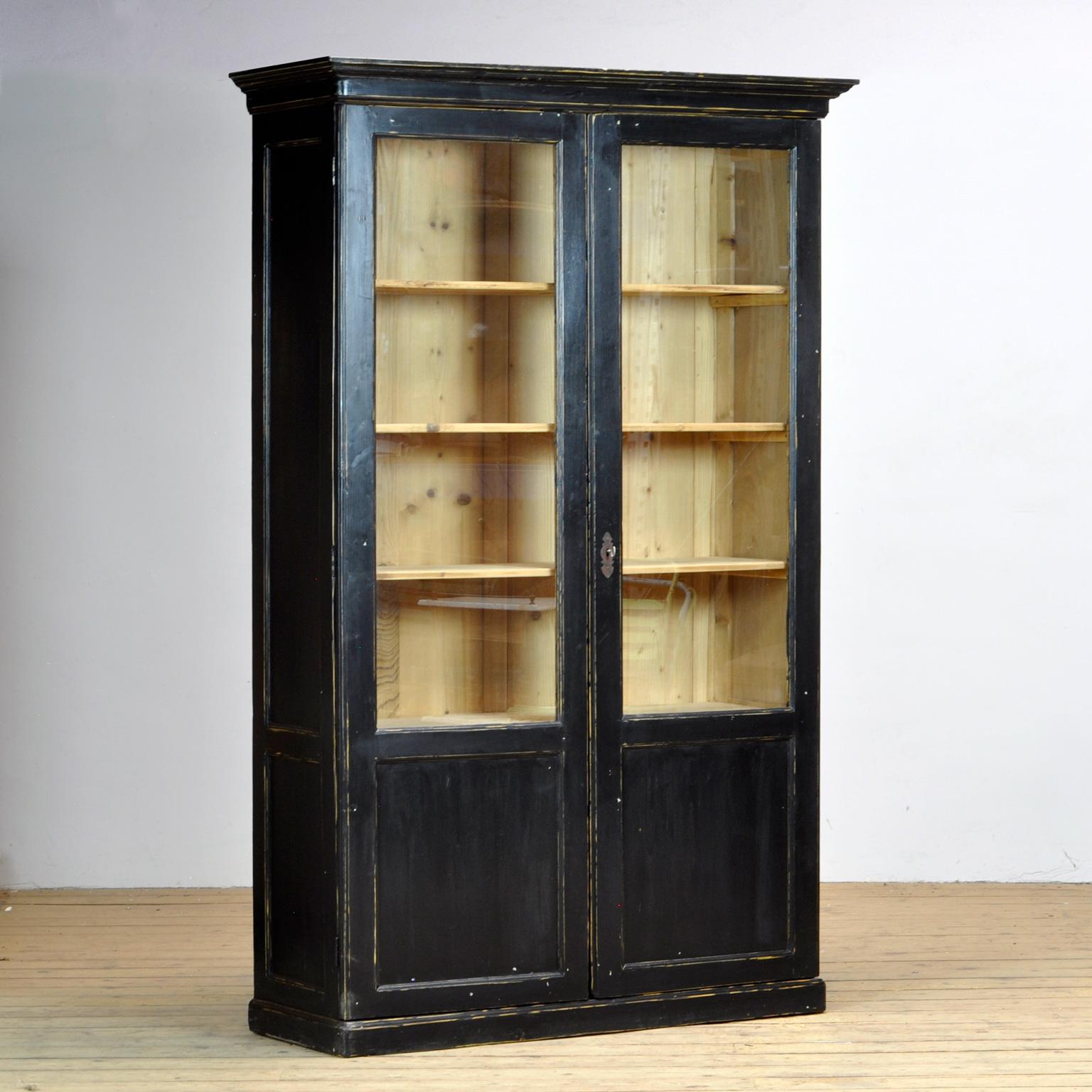 This pine display cabinet from the 1930's has been given new life with a professional black painted finish, lightly distressed to compliment the age and bring out the warmth of the pine.
At 223 cm tall, this will make a wonderful bookcase or display