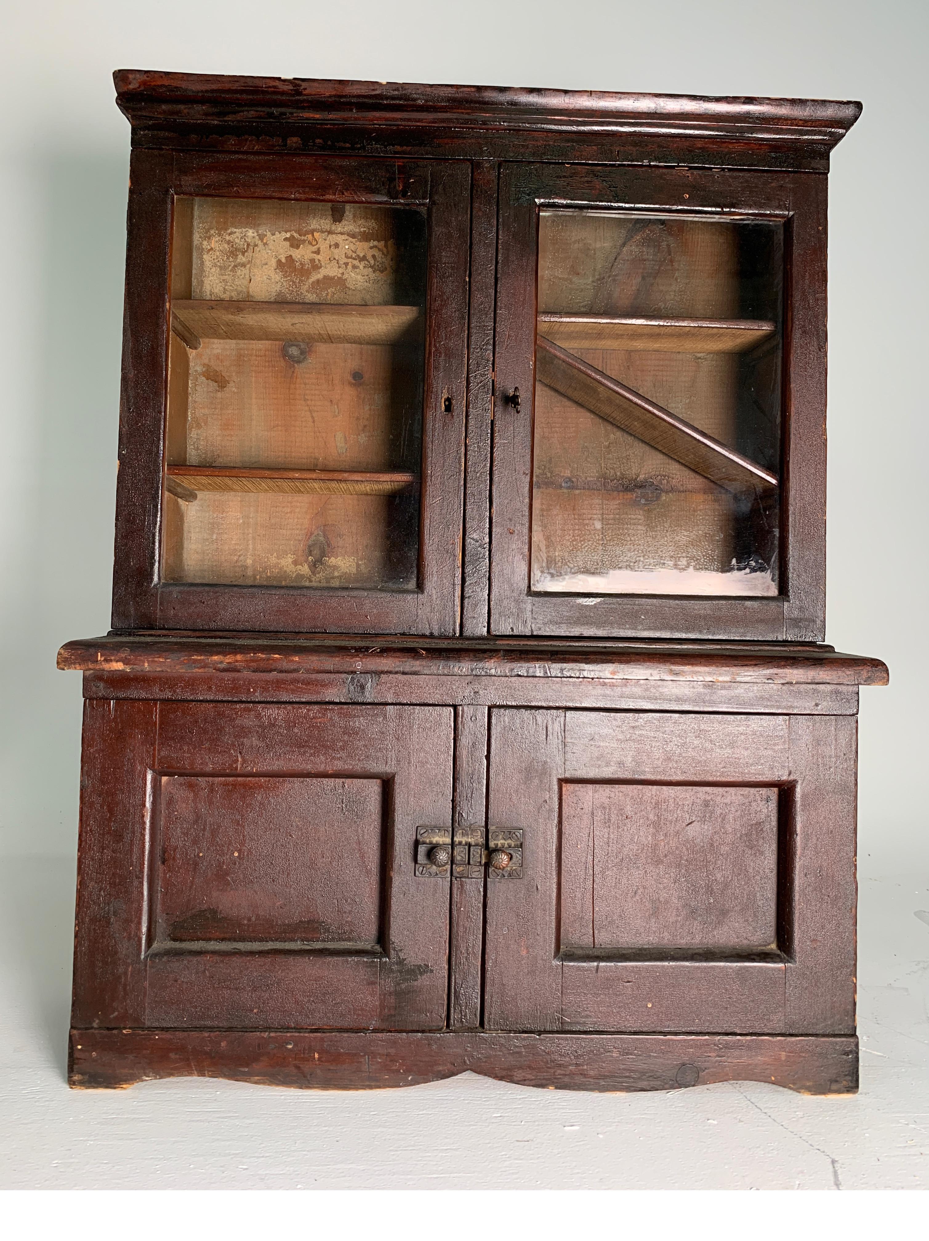 Mid-19th century child's step back dolls cupboard with glass pained doors, interior shelves, drawer with lover cabinet in stained pine, all original.