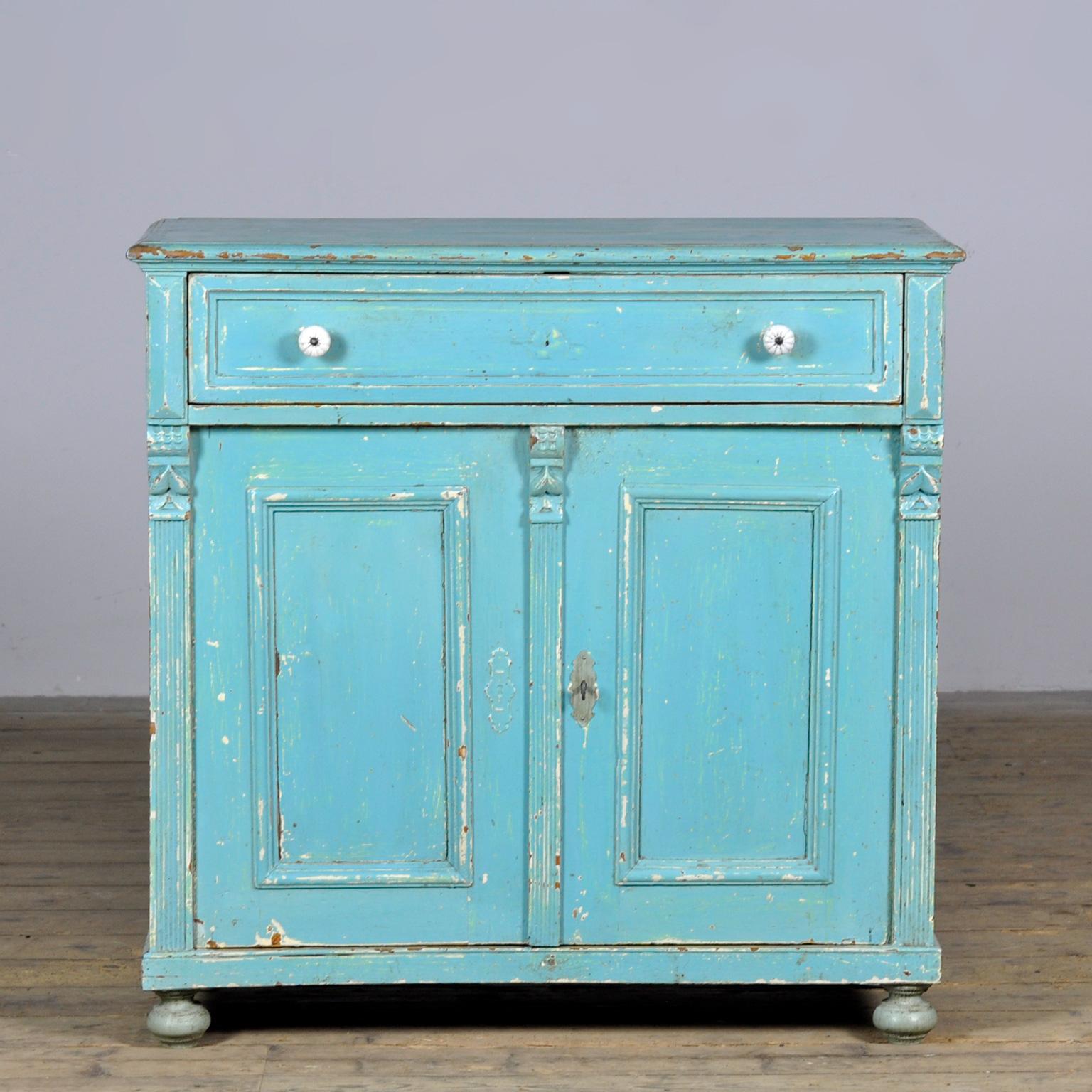 Pine sideboard from around 1910. The cabinet has its original paint with a nice patina. The cabinet has a well-functioning lock with key. This cabinet has been cleaned and treated against woodworm. A beautiful and practical piece of furniture with