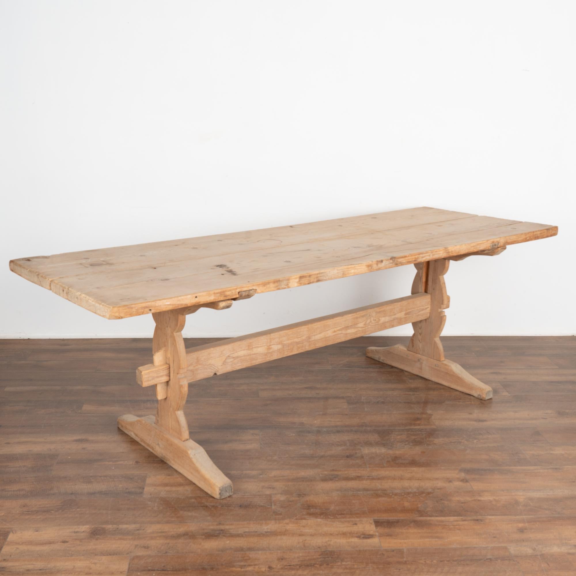 This wonderful old farm table from the Swedish countryside is almost 8' long. The natural pine shows off a warm and worn patina deepened through generations of use. 
There is a 17