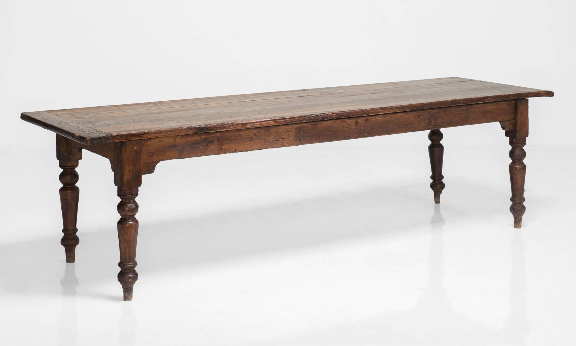 Pine farmhouse table, circa 1850.

Elegant and rustic dining table with sturdy base and turned legs.