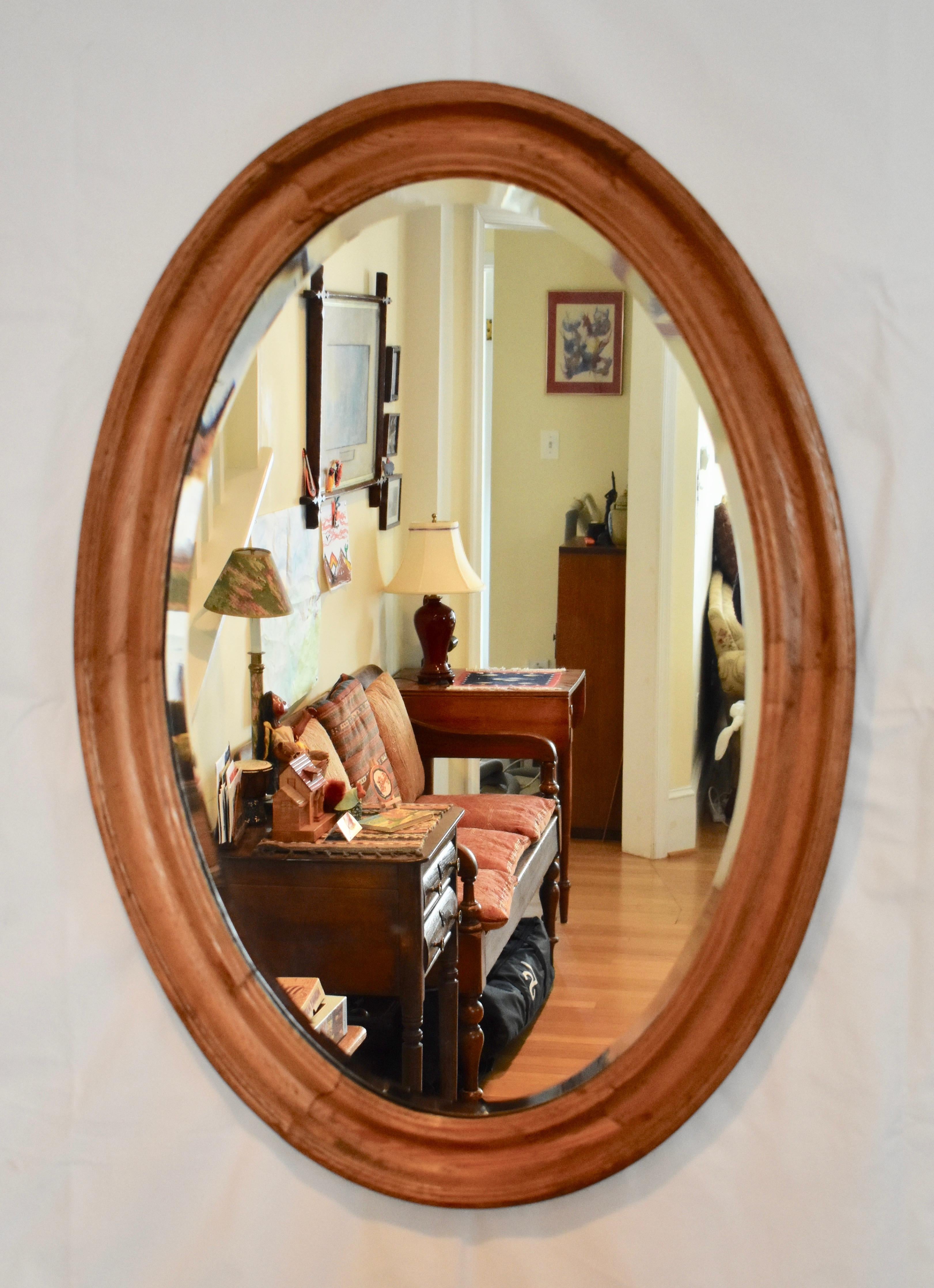 It is rare to find an oval antique English pine mirror with original glass. This nice example has a strong grain pattern and a beautifully contoured frame molding. It is perfectly suited for use in the bedroom, bathroom, or hallway.

  