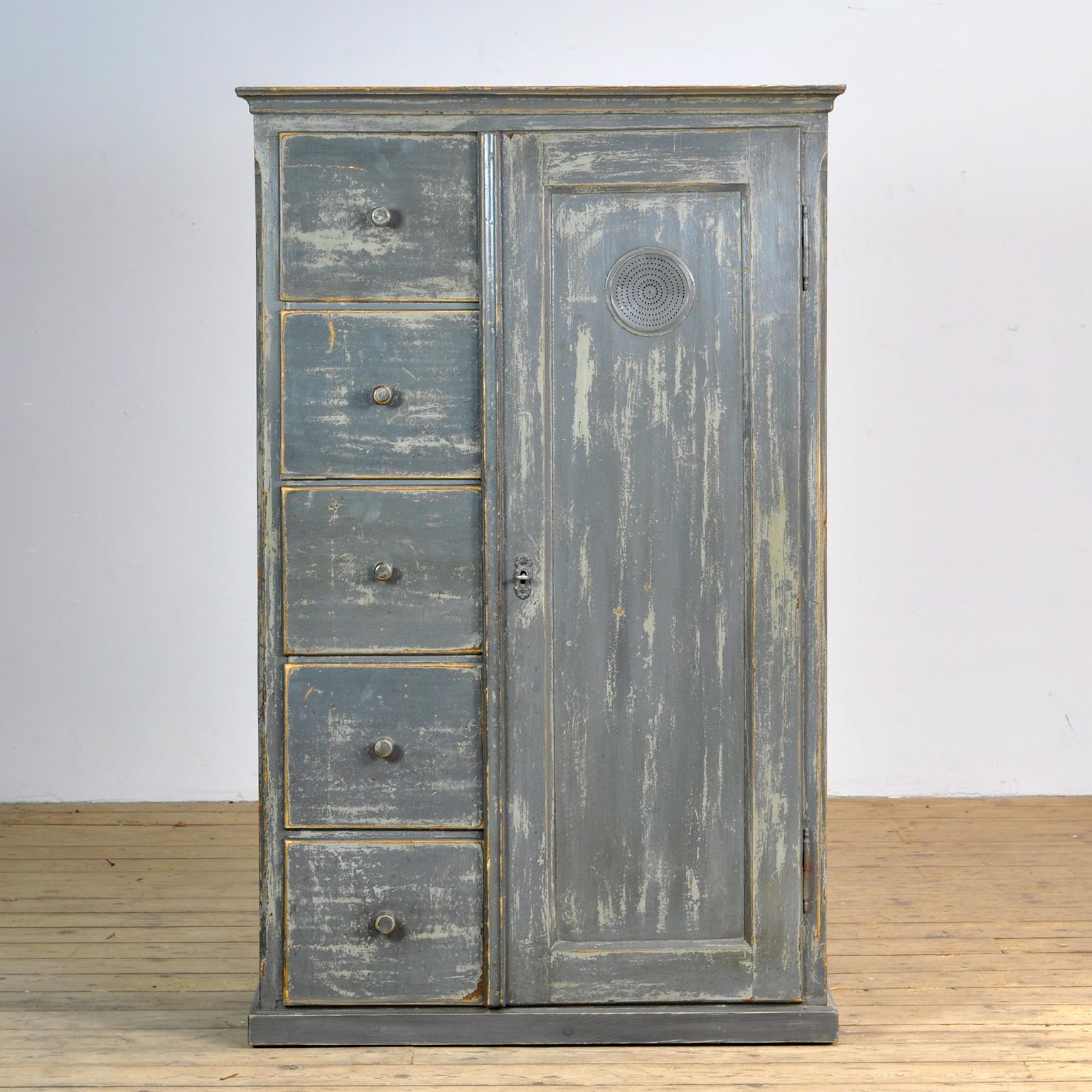 Pine cabinet from circa 1930. With 5 drawers made with dovetail joints and three shelves behind the door. working lock with key. Beautiful patina.