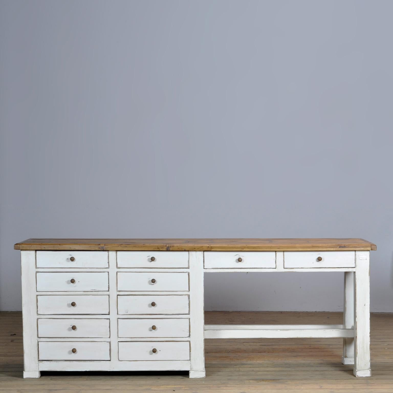 Pine worktable made in the 1950s. The table has 12 drawers for lots of storage space. For example to use as a kitchen worktable.