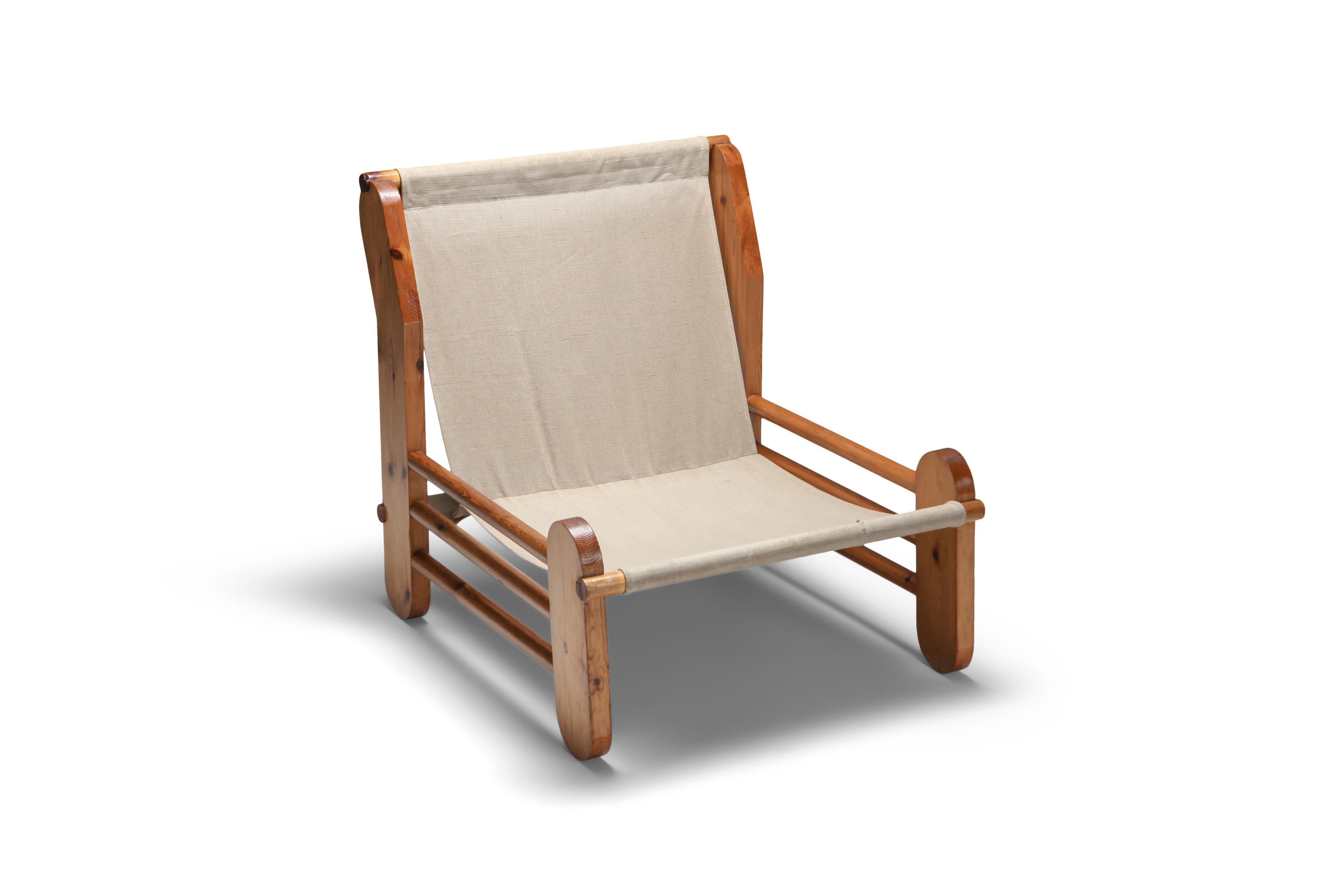 Architectural easy chair in pine and canvas.

European, 1970s.

 