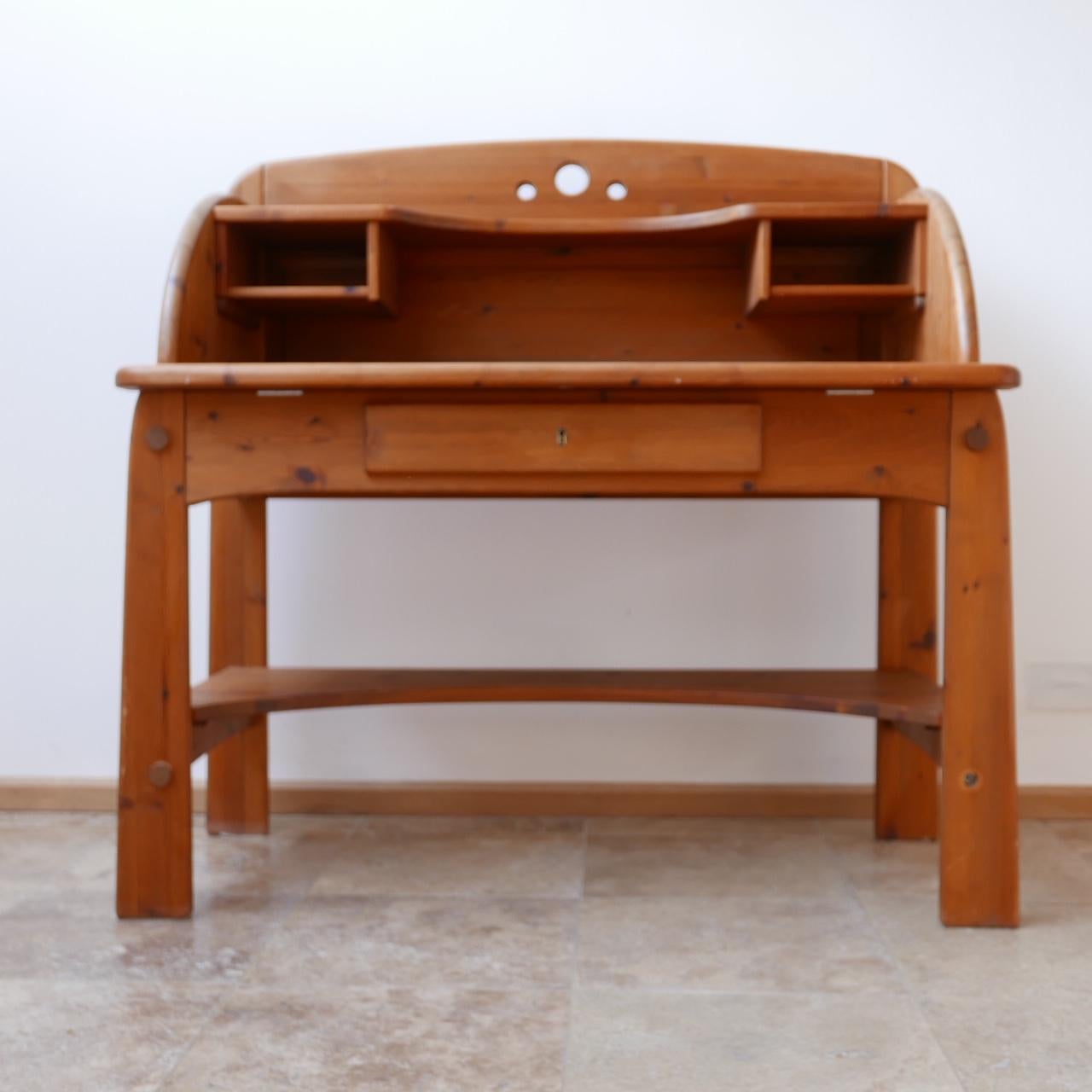 An unusual desk formed from pine with matching chair.

In the manner of Rainer Daumiller crossed with Gilbert Marklund.

Likely Swedish in origin.

The desk hides two secret drawers that pop down with a hidden catch making it ideal to hide