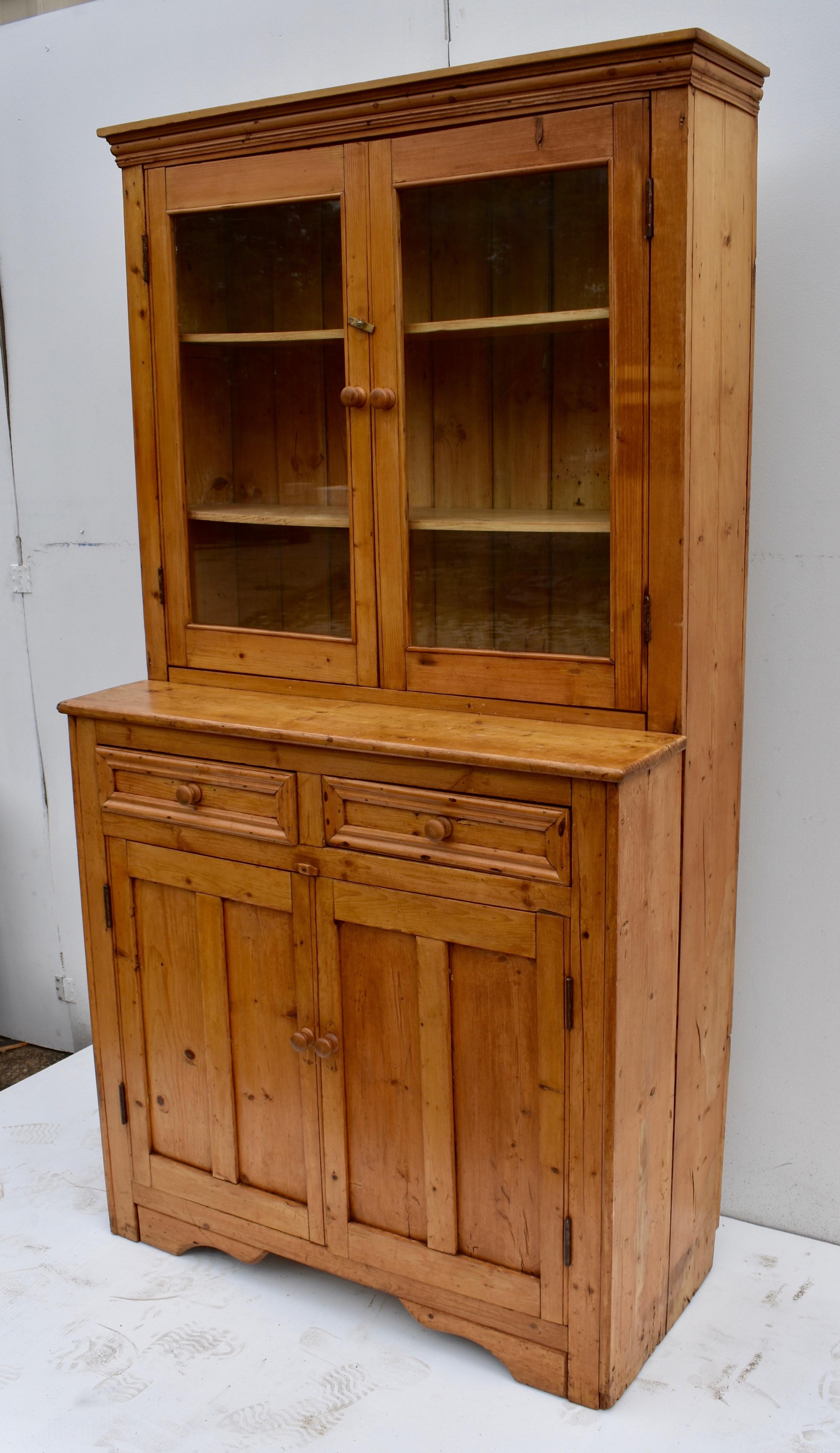 This is a fine example of an Irish glazed dresser from Co. Sligo, built in one piece, as is typical, and in almost entirely original condition.
The upper section features a bold crown molding above two wide-swinging doors which still retain their