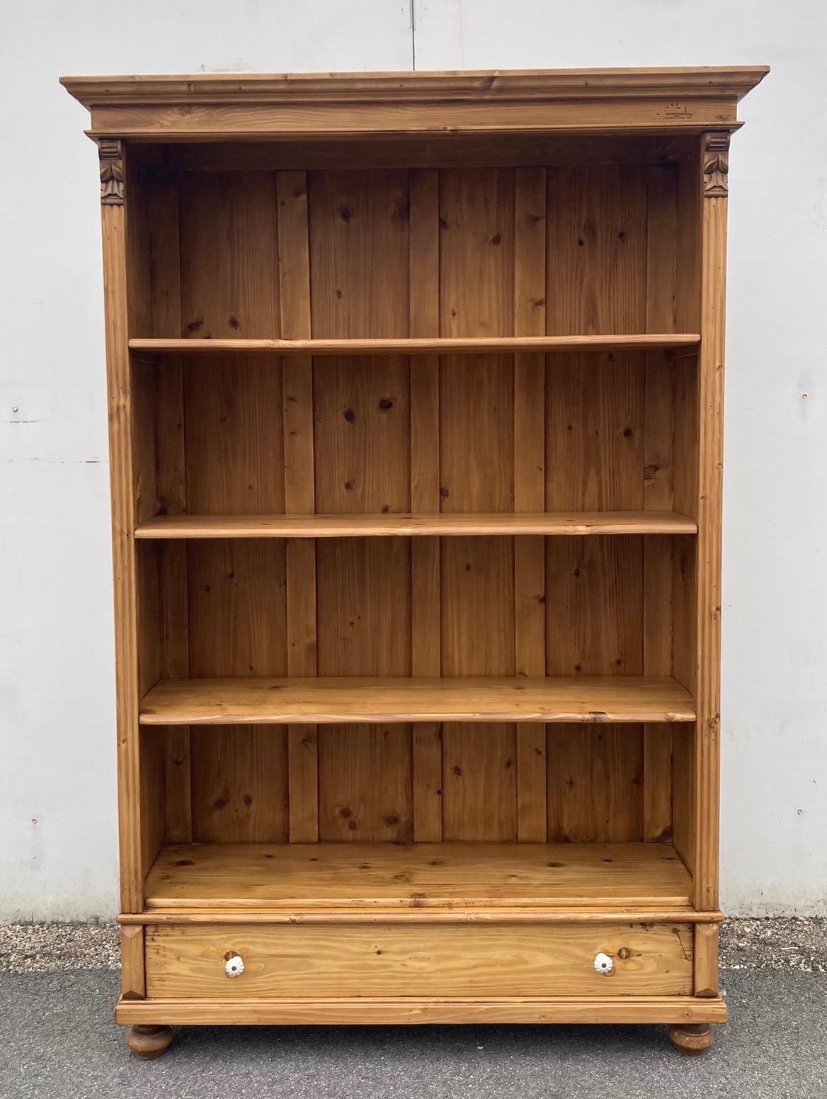 Antique pine bookcases are hard to find so the shell of this piece was provided by a vintage pine armoire.  With one board width removed from the sides and the original backboards and crown molding retained, with the drawer reduced in depth, we get