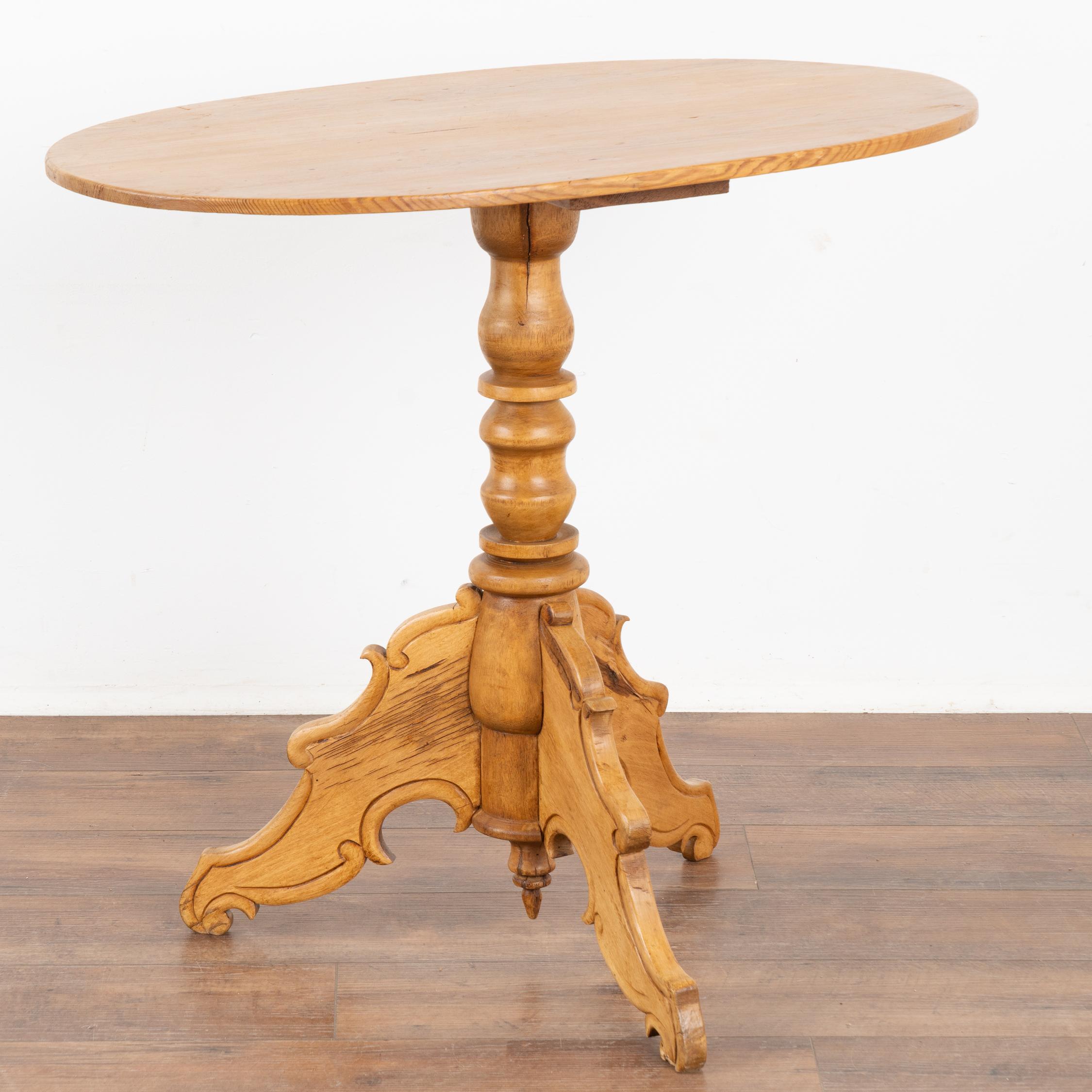 This antique oval pine side table is charming with it's softly rounded edges, turned pedestal base and decoratively carved tripod legs which were a traditional style in Sweden.
There is a gentle appeal to the balance of lines between the oval top,