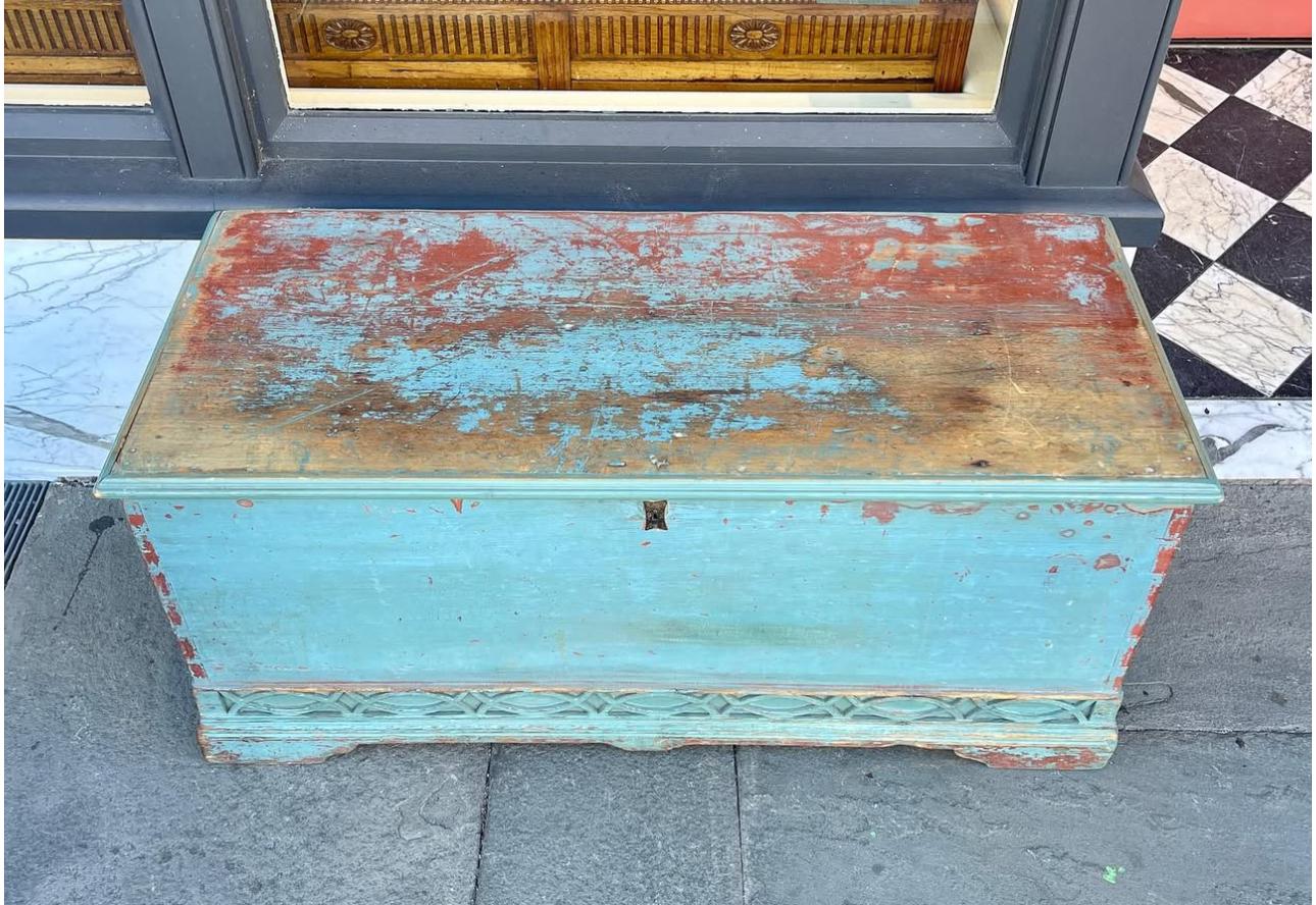 American blanket chest with unique base fretwork in old paint, blue  and red surface 