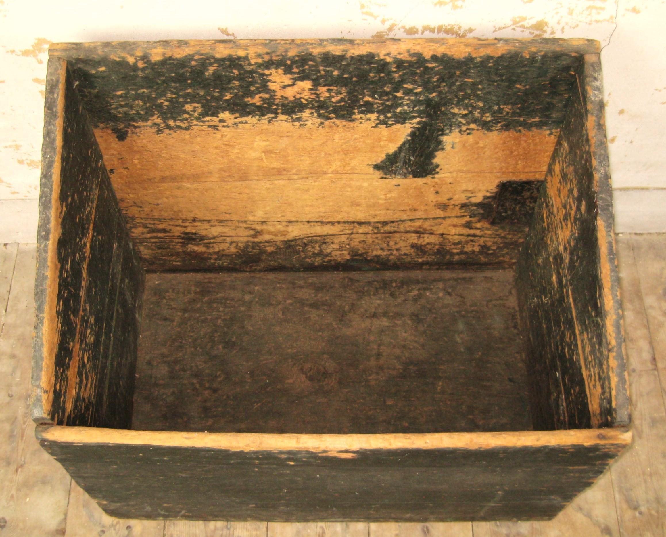 This is an early pine wooden box. Great for storing firewood. We used it as a recycling bin. Multi-functions with this great early pine box. Wonderful Black coloring on this! You don't find these anymore! A true antique piece that came out of my