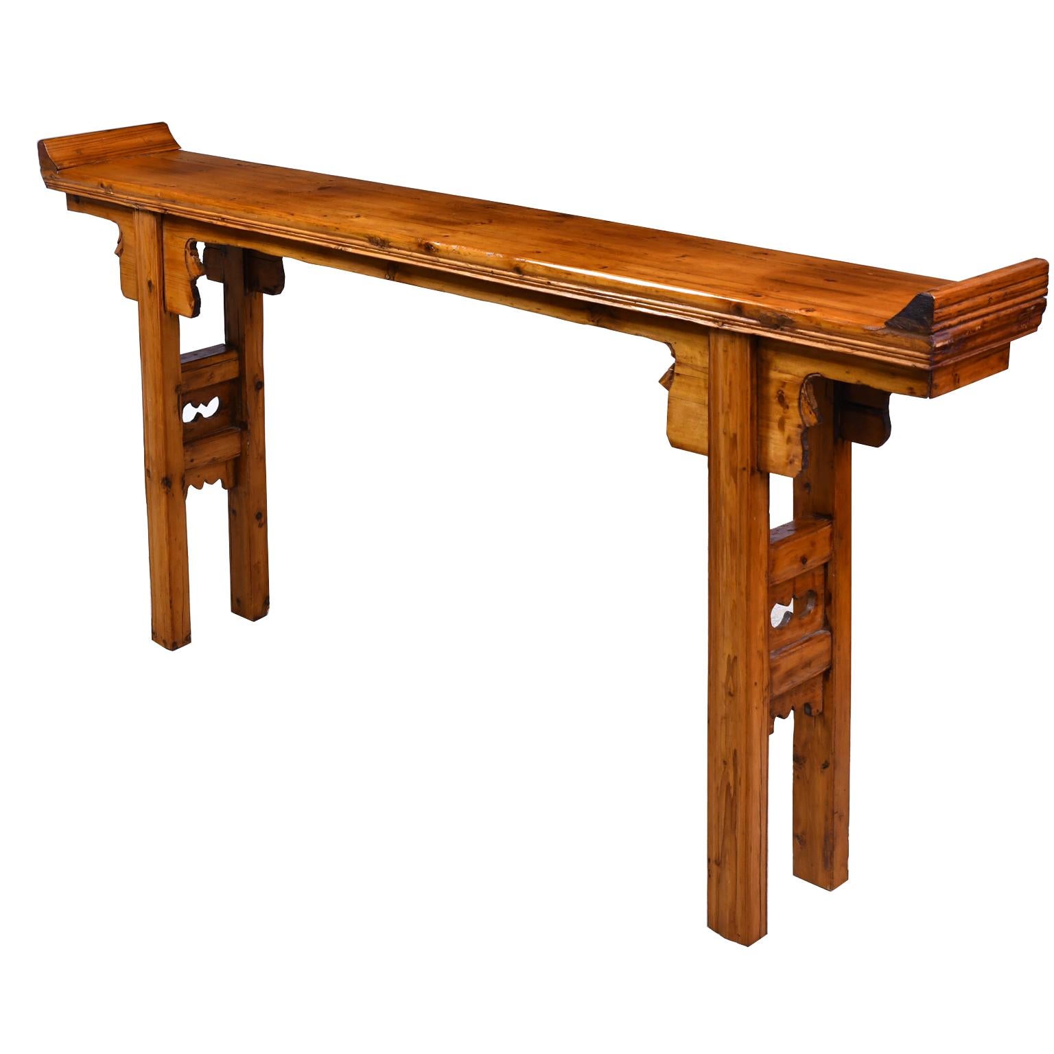 A Qing Chinese Altar table in elm and pine with everted ends on the top, square legs with carved stretchers and carved flanges. Shanxi, China, 20th century
Measures: 66