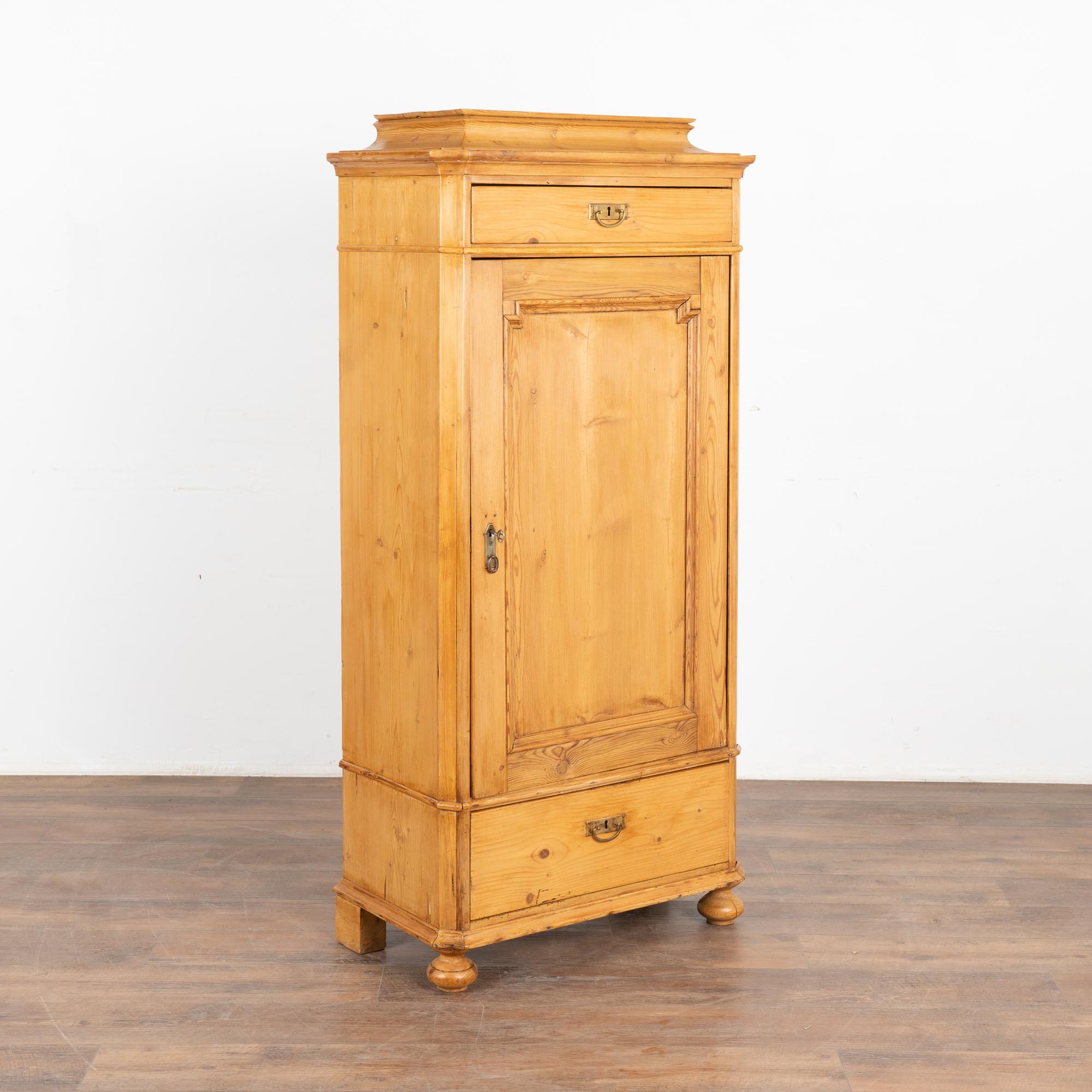 Narrow pine one door cabinet cabinet with interior shelving, exterior has one upper and lower drawer.
Made of pine, dovetail joints and brass pulls.
Restored, stable and ready for use; one key included; works best as pull only.
Any scratches,