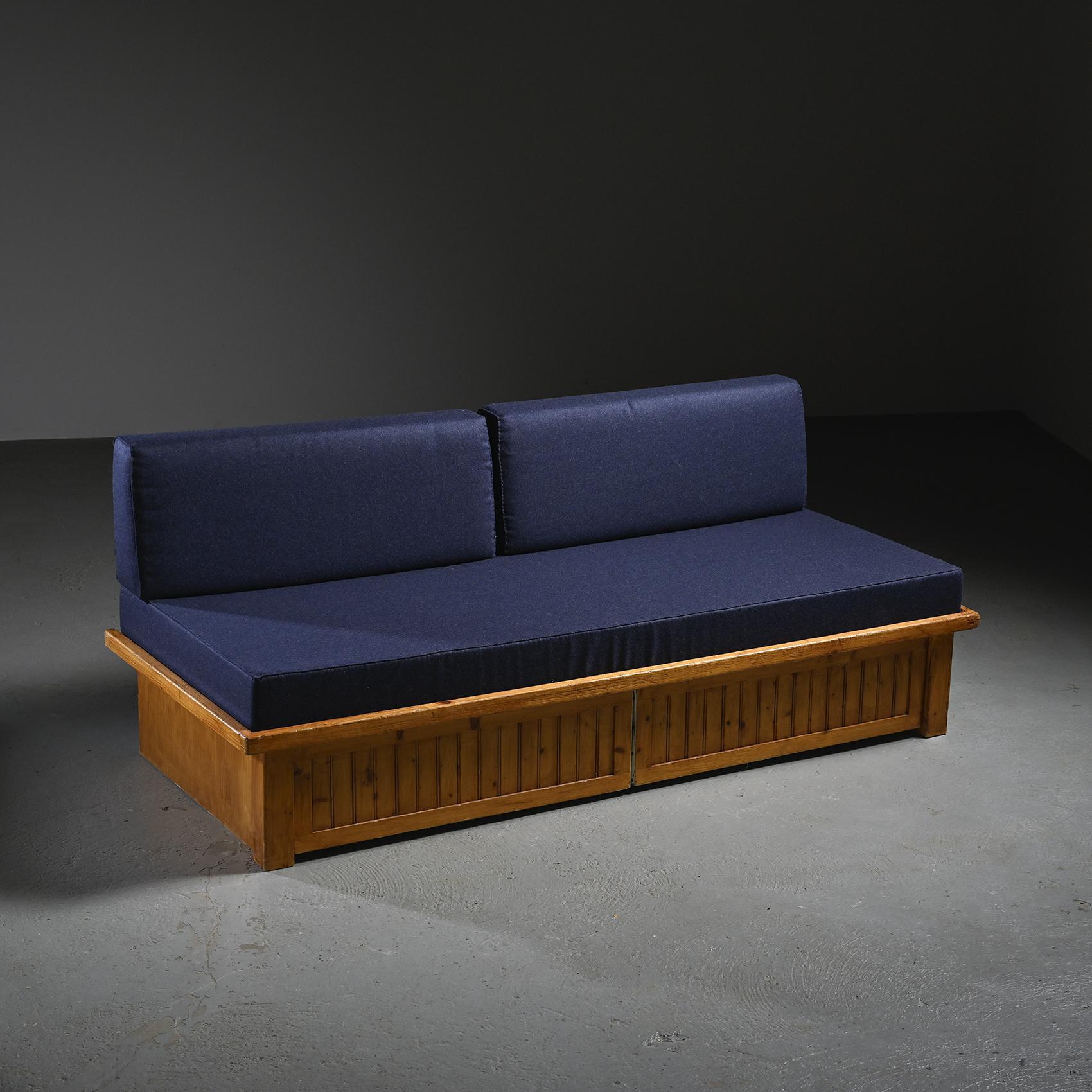 Sofa bed from the Résidence Nova in Les Arcs, designed by Charlotte Perriand as part of her large-scale project for the French Alpine resort.

Made of solid pine, the slatted frame incorporates two sliding drawers ingeniously concealed behind a