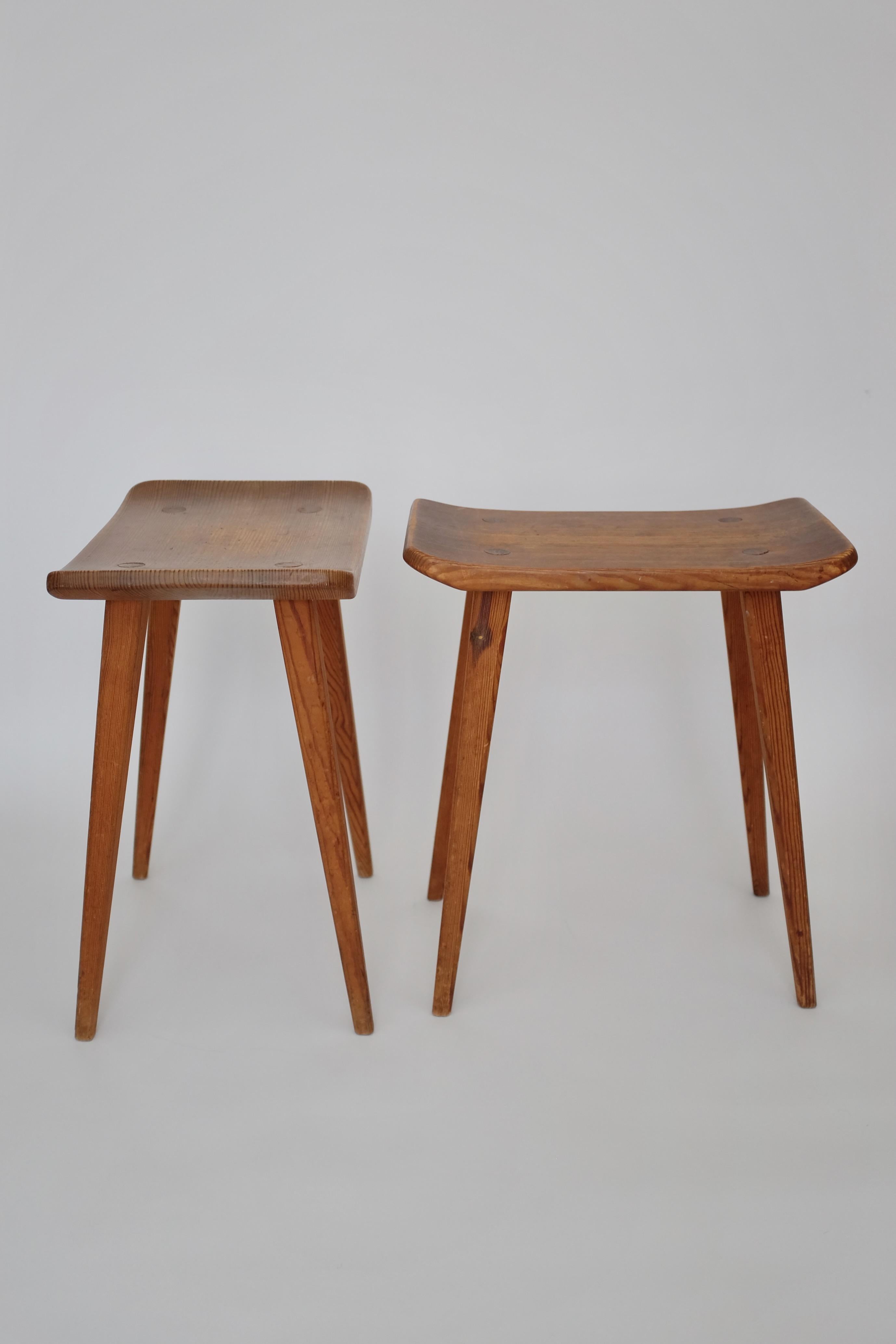 Charming Pair of Vintage Pine stools in model Visingsö by Carl Malmsten. Marked with the makers initials CM underneath and probably made by Carl Malmstens own studio sometime during the mid 20th century. The model was initially designed in 1953 and