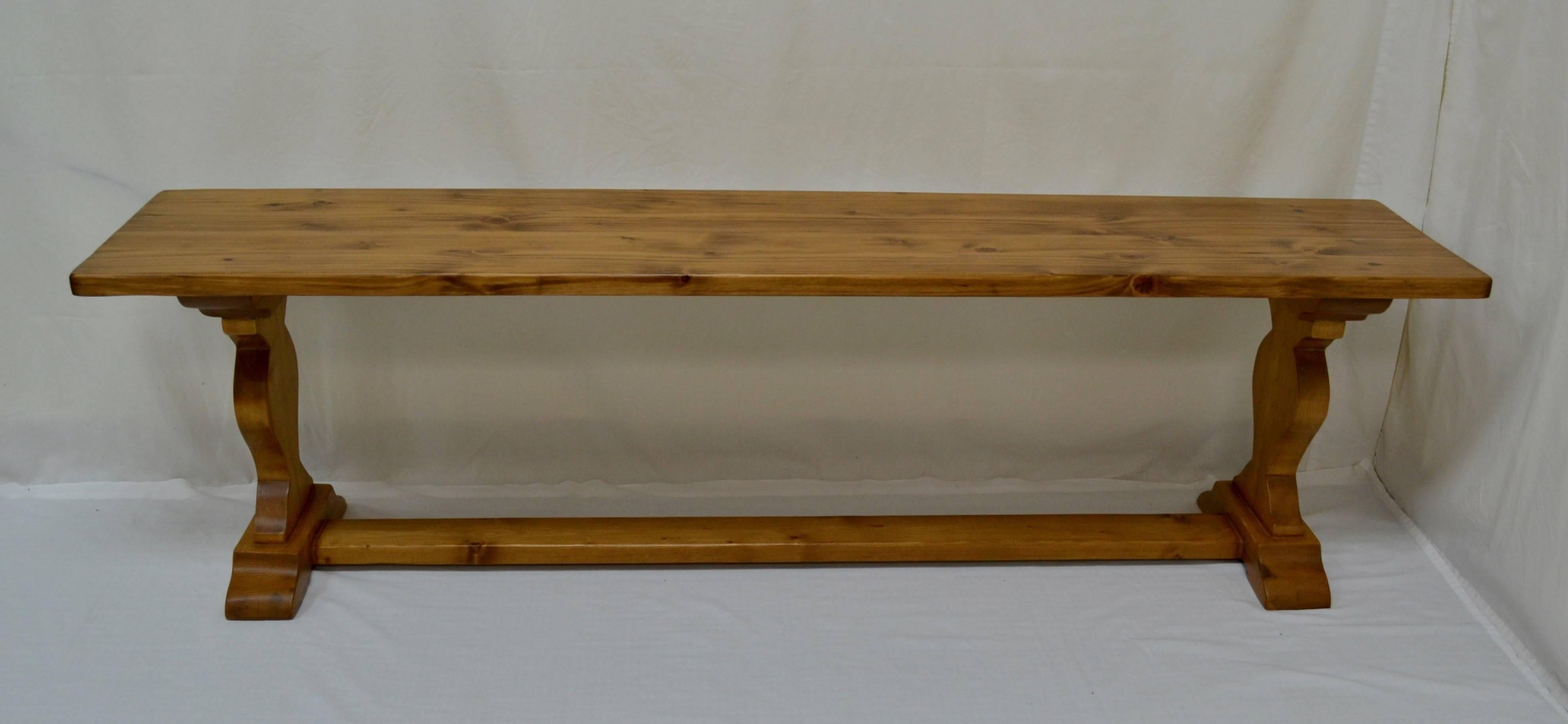 This is an attractive and sturdy pine refectory-style bench or form. The trestle ends are joined by a stretcher at floor level, between the sledge-style feet. In medium pine stain with a wipe-off satin lacquer finish.

