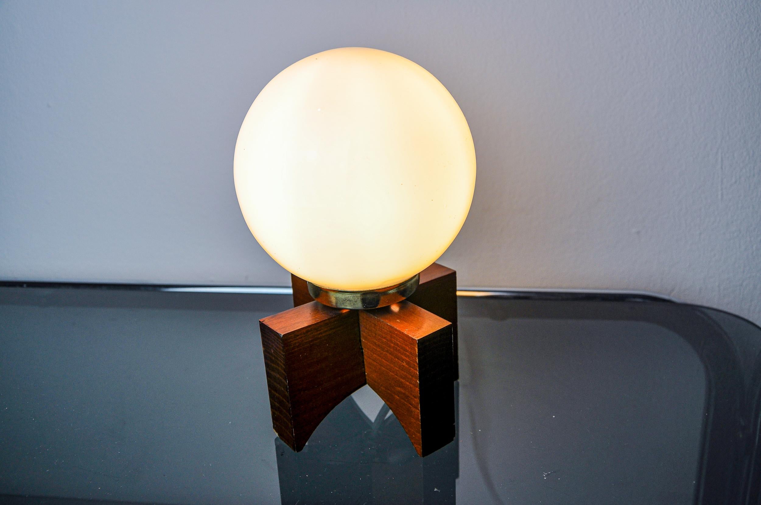 Very beautiful small table lamp designed and produced in Spain in the 1970s. Pine structure supporting an opaline glass globe. Very beautiful decorative object called folk art. When lit, this lamp diffuses a soft and subdued light. Electricity