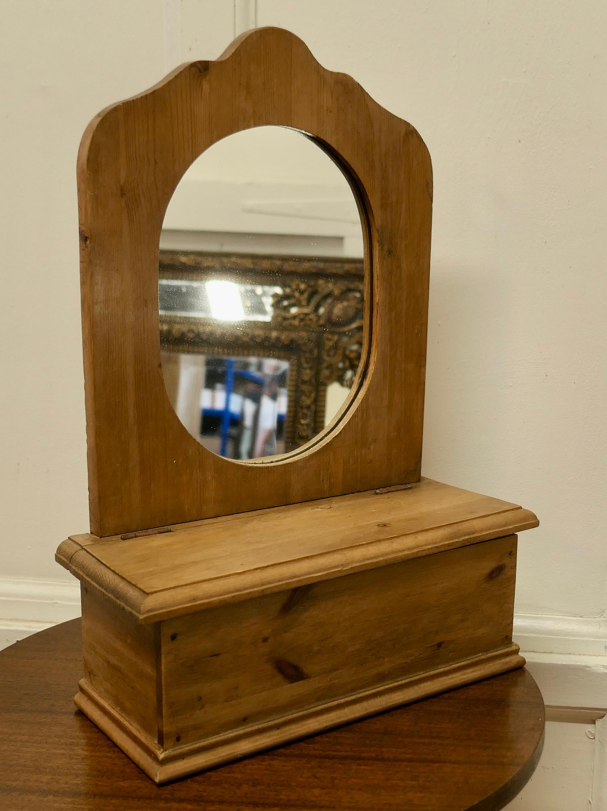 Pine toilet or vanity mirror
 
The mirror back has as scallop shape surrounding and Oval glass
Beneath there is a useful compartment with a lifting lid
The mirror is 14” wide and 6” deep, it is 20”high
THM166.