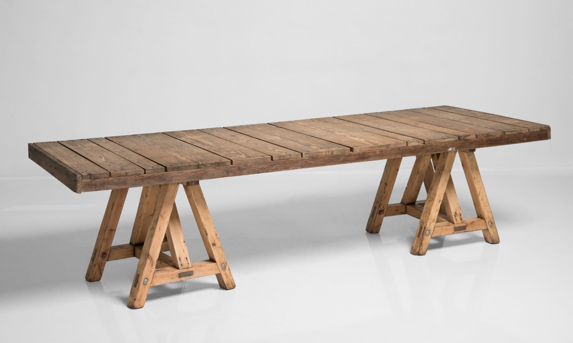 Pine trestle table, France circa 1930.

Rustic construction with plank top and substantial sawhorse legs.

Measures: 111.5