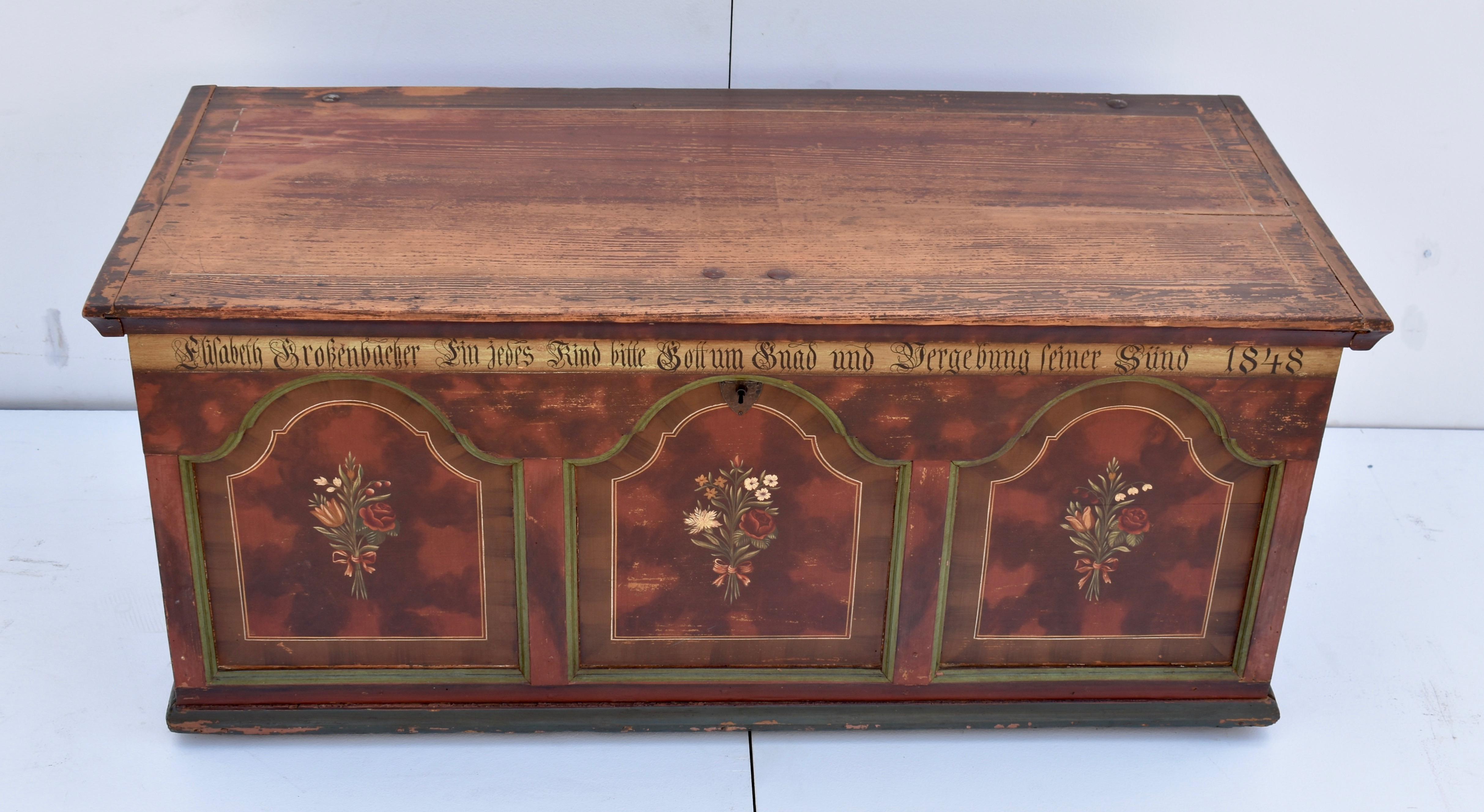 What a beautiful and interesting trunk, in original paint, from Germany. The front of the piece is sponged in shades of red and burgundy with three arched baroque-style panels, trimmed with green molding, equally spaced across the front. Inner faux