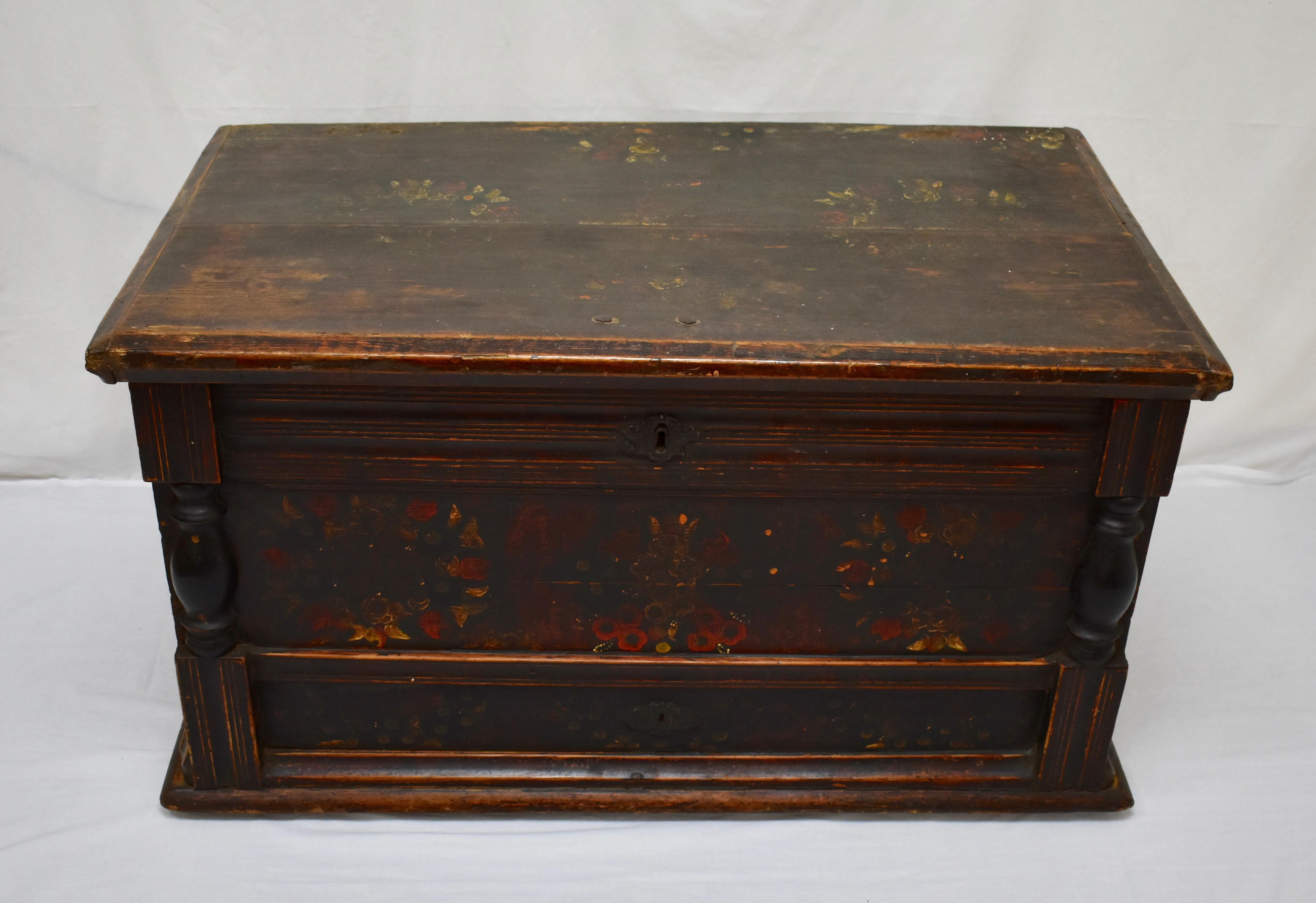 This large and handsome Baroque style pine trunk is built from stock over 1” thick and is in the form of a faux mule chest, that is, the lower front panel masquerades as a drawer. The upper front panel is boldly fluted from side to side, while the