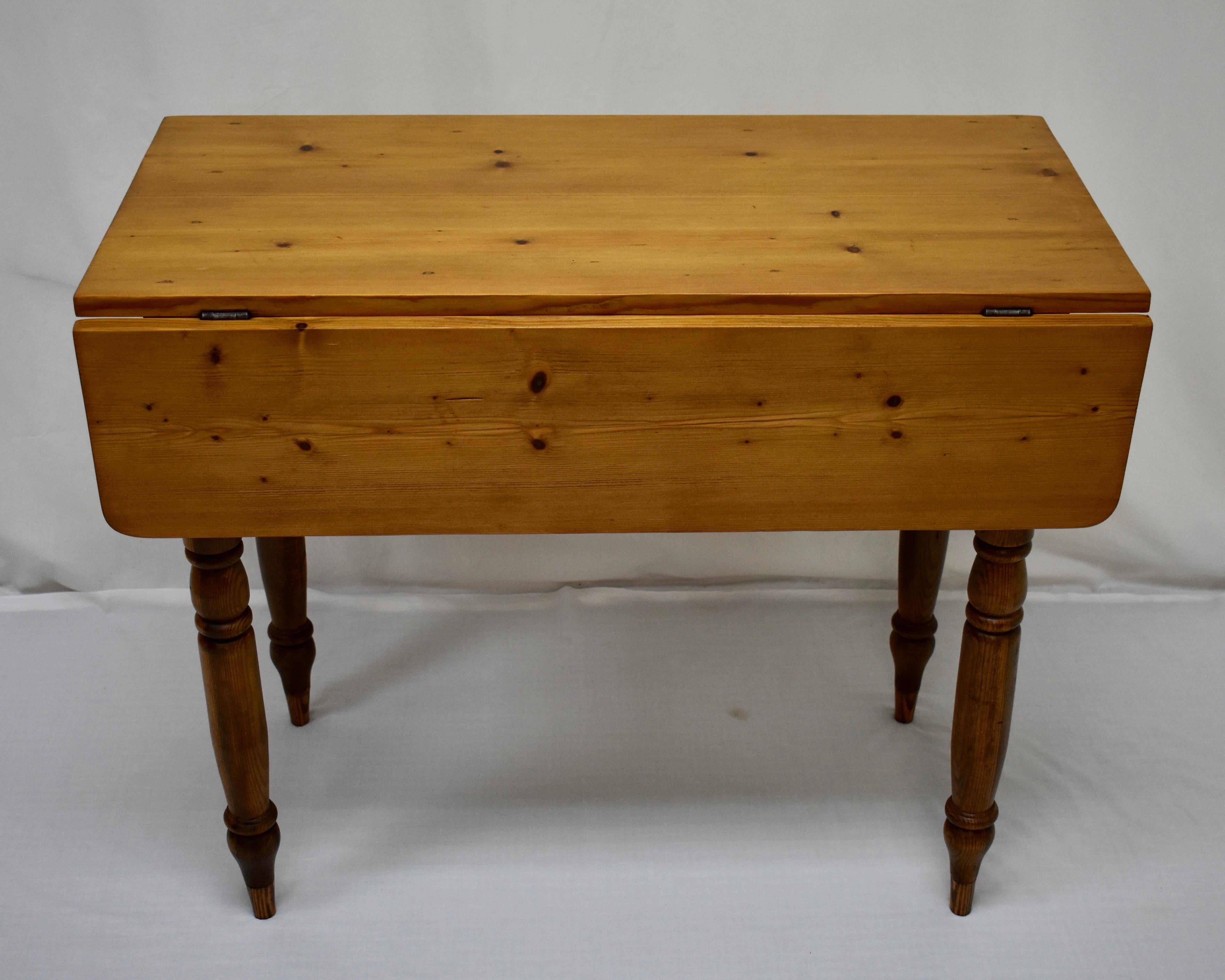 We don’t see many of these English pine drop-leaf tables so we were delighted to find this small version of a classic design. The beautiful two board top is only 18” deep, great for placement against a wall. With one leaf raised the surface is