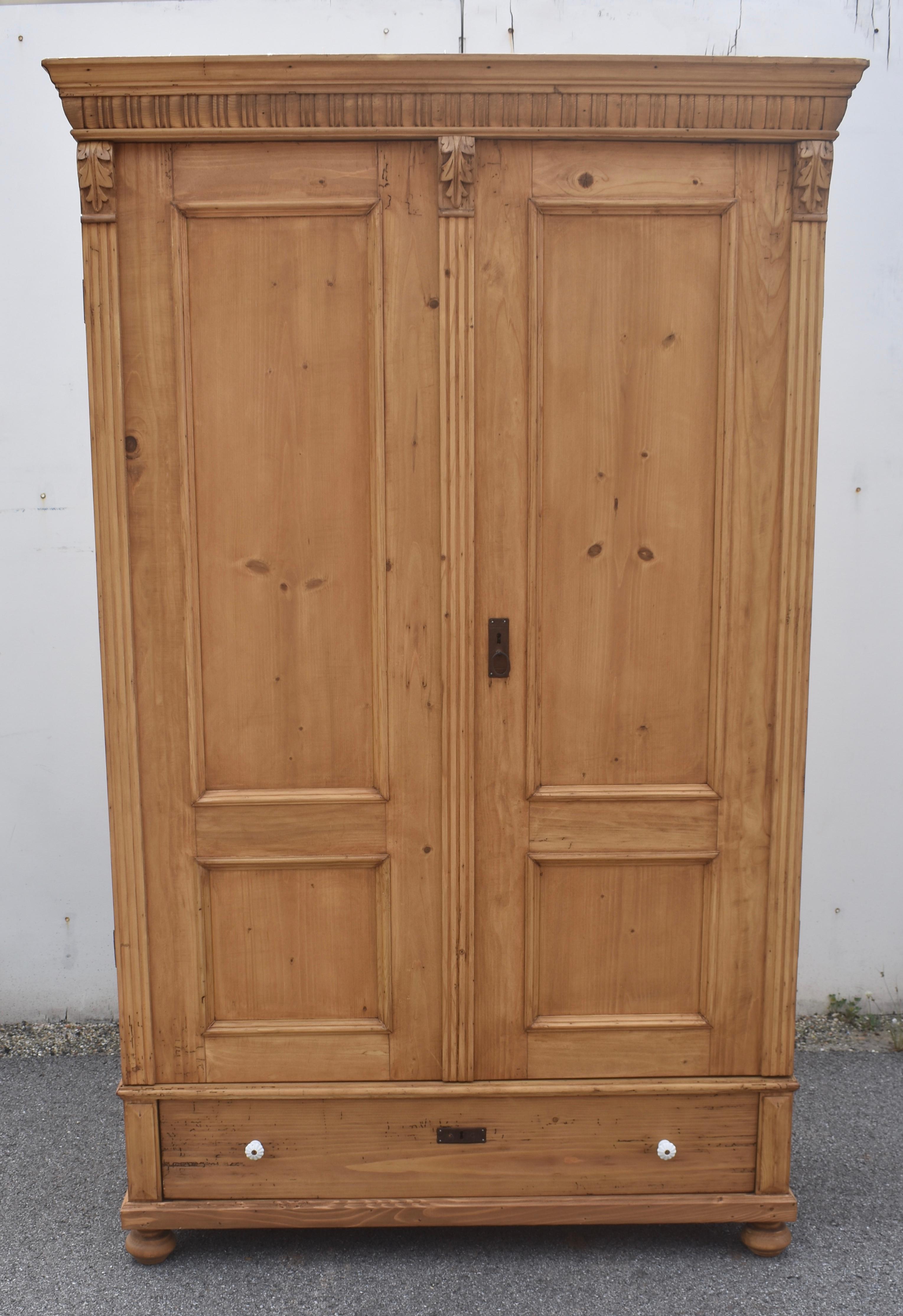 This beautiful armoire, a little taller than most, really has everything we like to see in a Central European wardrobe.  The crown is a graceful combination of ogee molding above a row of gadrooning.  The doors have two panels, one long rectangle