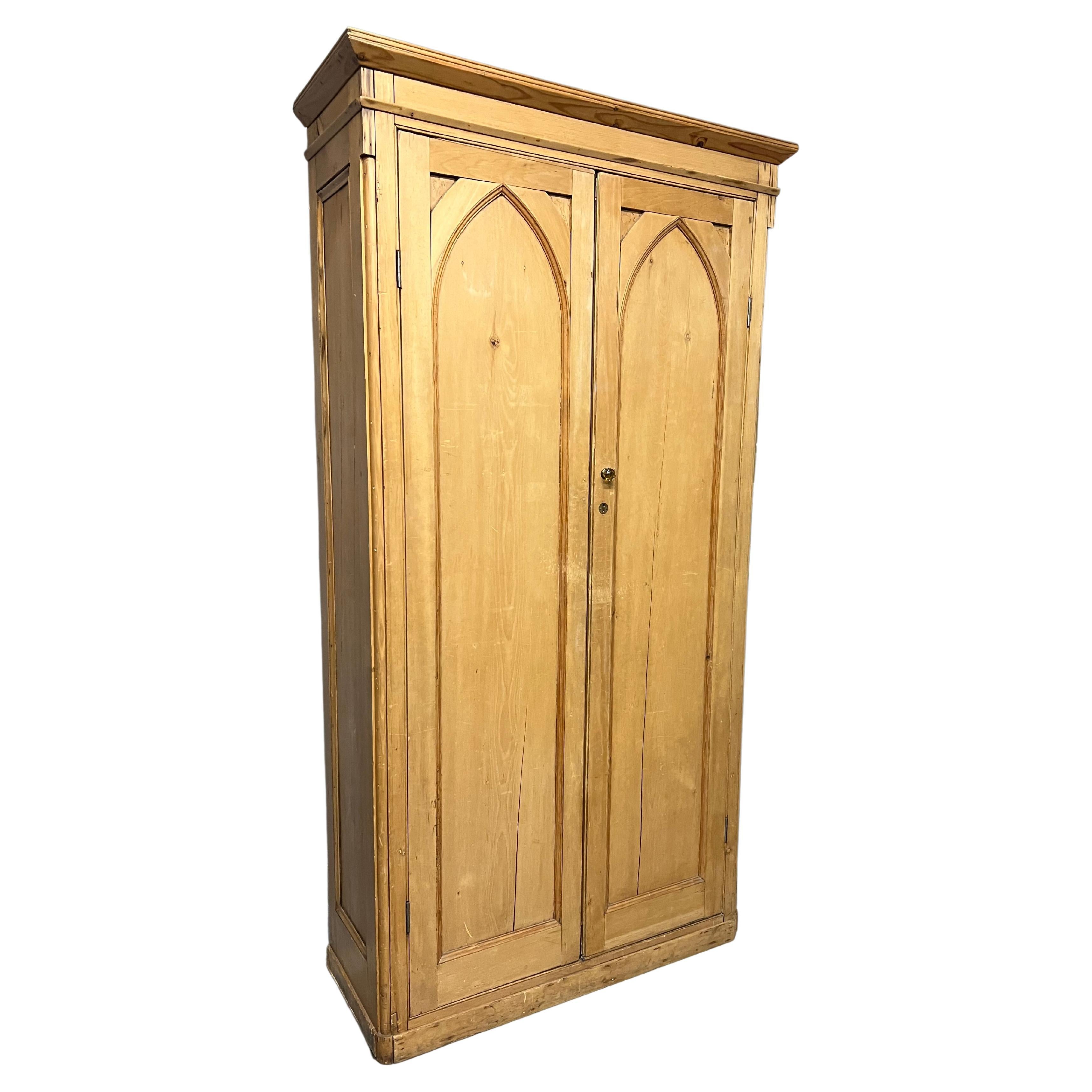 Pine armoire or cupboard - a terrific storage solution!

 Wonderful gothic detailing on this raw pine gives the feel of a Mexican church. This piece has 3 shelves, and the back panel has been cut to easily run cords. Great color, craftsmanship and