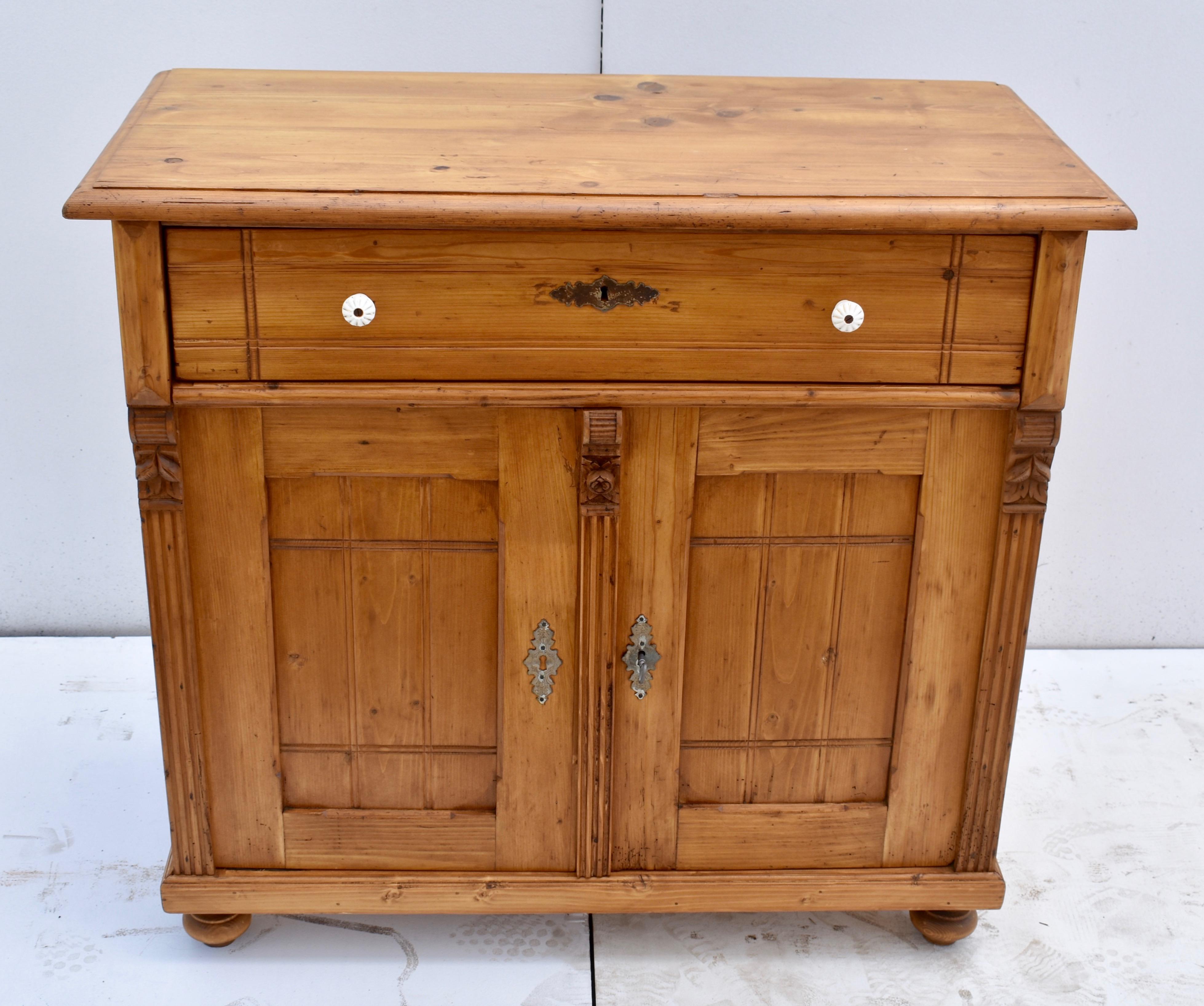This pretty little two door base has some interesting and unusual features. The top has a step-down edge and sits above a single long hand-cut dovetailed drawer. The drawer front bears a double row of criss-crossed incisions, a design that is